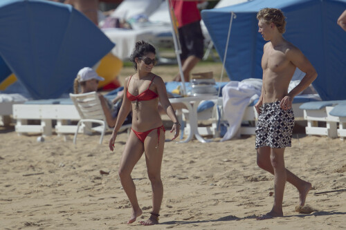 Back in each other's arms! Bikini-clad Vanessa Hudgens shares a steamy kiss with boyfriend Austin Butler as they are reunited in Hawaii

She's been promoting her latest movie Journey 2: The Mysterious Island, with her ex Josh Hutcherson and causing some confusion with the Australian press as to who's dating who.

But today, the bikini-clad 23-year-old was reunited with her current boyfriend Austin Butler in Hawaii, leaving onlookers with no doubt as to who has Vanessa 's heart now.

The couple, who have been dating since last September, are clearly very much in the honeymoon period of their relationship.

The High School Musical actress, who also dated co-star Zac Efron, looked stunning as she sported a tiny red string bikini in Hawaii.

She showed her athletic figure in the attire which she paired with some wooden-style jewellery accessories.

Vanessa and fellow Disney actor Austin, 20, frolicked in the ocean together, kissing and cuddling.

Their lovey-dovey behaviour akin to the last few weeks, with the couple just unable to keep their hands off each other.

When Vanessa and Austin started dating last year, friends said at the time that it was 'nothing serious', but the pair now seem to be inseparable.

They holidayed in Miami last month, visited Disneyland in Anaheim, California, and spent Christmas and New Year's together too.

Austin, who recently co-starred in the movie Sharpay's Fabulous Adventure, alongside Vanessa's best friend Ashley Tisdale, is three years younger than Vanessa.