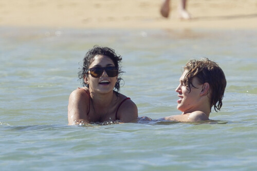 Back in each other's arms! Bikini-clad Vanessa Hudgens shares a steamy kiss with boyfriend Austin Butler as they are reunited in Hawaii

She's been promoting her latest movie Journey 2: The Mysterious Island, with her ex Josh Hutcherson and causing some confusion with the Australian press as to who's dating who.

But today, the bikini-clad 23-year-old was reunited with her current boyfriend Austin Butler in Hawaii, leaving onlookers with no doubt as to who has Vanessa 's heart now.

The couple, who have been dating since last September, are clearly very much in the honeymoon period of their relationship.

The High School Musical actress, who also dated co-star Zac Efron, looked stunning as she sported a tiny red string bikini in Hawaii.

She showed her athletic figure in the attire which she paired with some wooden-style jewellery accessories.

Vanessa and fellow Disney actor Austin, 20, frolicked in the ocean together, kissing and cuddling.

Their lovey-dovey behaviour akin to the last few weeks, with the couple just unable to keep their hands off each other.

When Vanessa and Austin started dating last year, friends said at the time that it was 'nothing serious', but the pair now seem to be inseparable.

They holidayed in Miami last month, visited Disneyland in Anaheim, California, and spent Christmas and New Year's together too.

Austin, who recently co-starred in the movie Sharpay's Fabulous Adventure, alongside Vanessa's best friend Ashley Tisdale, is three years younger than Vanessa.