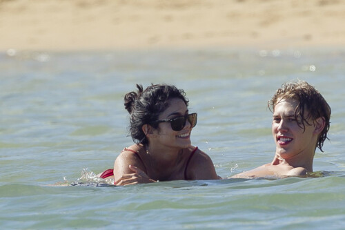 Back in each other's arms! Bikini-clad Vanessa Hudgens shares a steamy kiss with boyfriend Austin Butler as they are reunited in Hawaii

She's been promoting her latest movie Journey 2: The Mysterious Island, with her ex Josh Hutcherson and causing some confusion with the Australian press as to who's dating who.

But today, the bikini-clad 23-year-old was reunited with her current boyfriend Austin Butler in Hawaii, leaving onlookers with no doubt as to who has Vanessa 's heart now.

The couple, who have been dating since last September, are clearly very much in the honeymoon period of their relationship.

The High School Musical actress, who also dated co-star Zac Efron, looked stunning as she sported a tiny red string bikini in Hawaii.

She showed her athletic figure in the attire which she paired with some wooden-style jewellery accessories.

Vanessa and fellow Disney actor Austin, 20, frolicked in the ocean together, kissing and cuddling.

Their lovey-dovey behaviour akin to the last few weeks, with the couple just unable to keep their hands off each other.

When Vanessa and Austin started dating last year, friends said at the time that it was 'nothing serious', but the pair now seem to be inseparable.

They holidayed in Miami last month, visited Disneyland in Anaheim, California, and spent Christmas and New Year's together too.

Austin, who recently co-starred in the movie Sharpay's Fabulous Adventure, alongside Vanessa's best friend Ashley Tisdale, is three years younger than Vanessa.