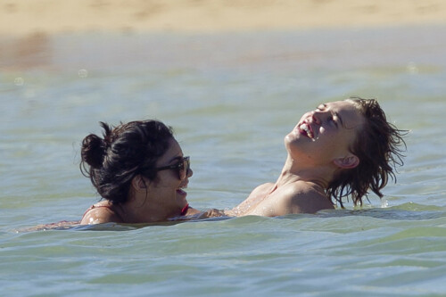 Back in each other's arms! Bikini-clad Vanessa Hudgens shares a steamy kiss with boyfriend Austin Butler as they are reunited in Hawaii

She's been promoting her latest movie Journey 2: The Mysterious Island, with her ex Josh Hutcherson and causing some confusion with the Australian press as to who's dating who.

But today, the bikini-clad 23-year-old was reunited with her current boyfriend Austin Butler in Hawaii, leaving onlookers with no doubt as to who has Vanessa 's heart now.

The couple, who have been dating since last September, are clearly very much in the honeymoon period of their relationship.

The High School Musical actress, who also dated co-star Zac Efron, looked stunning as she sported a tiny red string bikini in Hawaii.

She showed her athletic figure in the attire which she paired with some wooden-style jewellery accessories.

Vanessa and fellow Disney actor Austin, 20, frolicked in the ocean together, kissing and cuddling.

Their lovey-dovey behaviour akin to the last few weeks, with the couple just unable to keep their hands off each other.

When Vanessa and Austin started dating last year, friends said at the time that it was 'nothing serious', but the pair now seem to be inseparable.

They holidayed in Miami last month, visited Disneyland in Anaheim, California, and spent Christmas and New Year's together too.

Austin, who recently co-starred in the movie Sharpay's Fabulous Adventure, alongside Vanessa's best friend Ashley Tisdale, is three years younger than Vanessa.