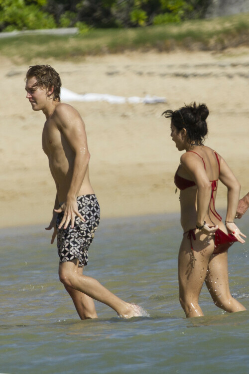 Back in each other's arms! Bikini-clad Vanessa Hudgens shares a steamy kiss with boyfriend Austin Butler as they are reunited in Hawaii

She's been promoting her latest movie Journey 2: The Mysterious Island, with her ex Josh Hutcherson and causing some confusion with the Australian press as to who's dating who.

But today, the bikini-clad 23-year-old was reunited with her current boyfriend Austin Butler in Hawaii, leaving onlookers with no doubt as to who has Vanessa 's heart now.

The couple, who have been dating since last September, are clearly very much in the honeymoon period of their relationship.

The High School Musical actress, who also dated co-star Zac Efron, looked stunning as she sported a tiny red string bikini in Hawaii.

She showed her athletic figure in the attire which she paired with some wooden-style jewellery accessories.

Vanessa and fellow Disney actor Austin, 20, frolicked in the ocean together, kissing and cuddling.

Their lovey-dovey behaviour akin to the last few weeks, with the couple just unable to keep their hands off each other.

When Vanessa and Austin started dating last year, friends said at the time that it was 'nothing serious', but the pair now seem to be inseparable.

They holidayed in Miami last month, visited Disneyland in Anaheim, California, and spent Christmas and New Year's together too.

Austin, who recently co-starred in the movie Sharpay's Fabulous Adventure, alongside Vanessa's best friend Ashley Tisdale, is three years younger than Vanessa.