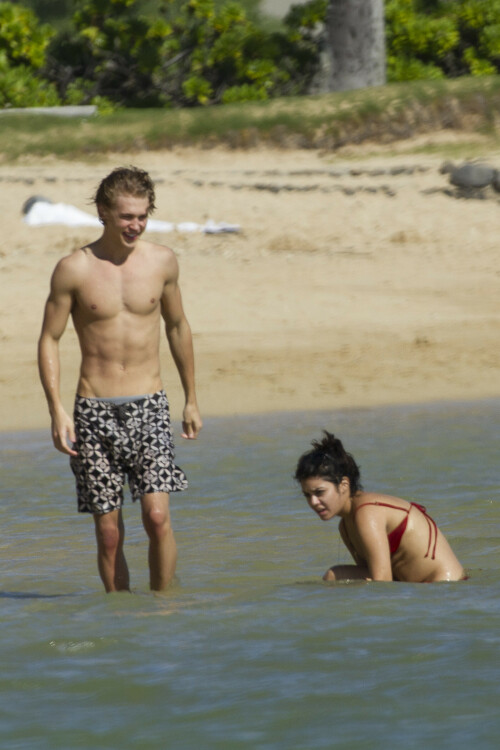 Back in each other's arms! Bikini-clad Vanessa Hudgens shares a steamy kiss with boyfriend Austin Butler as they are reunited in Hawaii

She's been promoting her latest movie Journey 2: The Mysterious Island, with her ex Josh Hutcherson and causing some confusion with the Australian press as to who's dating who.

But today, the bikini-clad 23-year-old was reunited with her current boyfriend Austin Butler in Hawaii, leaving onlookers with no doubt as to who has Vanessa 's heart now.

The couple, who have been dating since last September, are clearly very much in the honeymoon period of their relationship.

The High School Musical actress, who also dated co-star Zac Efron, looked stunning as she sported a tiny red string bikini in Hawaii.

She showed her athletic figure in the attire which she paired with some wooden-style jewellery accessories.

Vanessa and fellow Disney actor Austin, 20, frolicked in the ocean together, kissing and cuddling.

Their lovey-dovey behaviour akin to the last few weeks, with the couple just unable to keep their hands off each other.

When Vanessa and Austin started dating last year, friends said at the time that it was 'nothing serious', but the pair now seem to be inseparable.

They holidayed in Miami last month, visited Disneyland in Anaheim, California, and spent Christmas and New Year's together too.

Austin, who recently co-starred in the movie Sharpay's Fabulous Adventure, alongside Vanessa's best friend Ashley Tisdale, is three years younger than Vanessa.