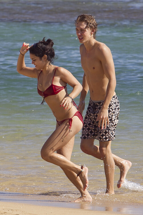 Back in each other's arms! Bikini-clad Vanessa Hudgens shares a steamy kiss with boyfriend Austin Butler as they are reunited in Hawaii

She's been promoting her latest movie Journey 2: The Mysterious Island, with her ex Josh Hutcherson and causing some confusion with the Australian press as to who's dating who.

But today, the bikini-clad 23-year-old was reunited with her current boyfriend Austin Butler in Hawaii, leaving onlookers with no doubt as to who has Vanessa 's heart now.

The couple, who have been dating since last September, are clearly very much in the honeymoon period of their relationship.

The High School Musical actress, who also dated co-star Zac Efron, looked stunning as she sported a tiny red string bikini in Hawaii.

She showed her athletic figure in the attire which she paired with some wooden-style jewellery accessories.

Vanessa and fellow Disney actor Austin, 20, frolicked in the ocean together, kissing and cuddling.

Their lovey-dovey behaviour akin to the last few weeks, with the couple just unable to keep their hands off each other.

When Vanessa and Austin started dating last year, friends said at the time that it was 'nothing serious', but the pair now seem to be inseparable.

They holidayed in Miami last month, visited Disneyland in Anaheim, California, and spent Christmas and New Year's together too.

Austin, who recently co-starred in the movie Sharpay's Fabulous Adventure, alongside Vanessa's best friend Ashley Tisdale, is three years younger than Vanessa.