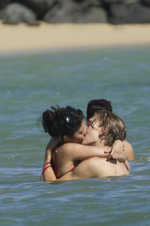 Back in each other's arms! Bikini-clad Vanessa Hudgens shares a steamy kiss with boyfriend Austin Butler as they are reunited in Hawaii

She's been promoting her latest movie Journey 2: The Mysterious Island, with her ex Josh Hutcherson and causing some confusion with the Australian press as to who's dating who.

But today, the bikini-clad 23-year-old was reunited with her current boyfriend Austin Butler in Hawaii, leaving onlookers with no doubt as to who has Vanessa 's heart now.

The couple, who have been dating since last September, are clearly very much in the honeymoon period of their relationship.

The High School Musical actress, who also dated co-star Zac Efron, looked stunning as she sported a tiny red string bikini in Hawaii.

She showed her athletic figure in the attire which she paired with some wooden-style jewellery accessories.

Vanessa and fellow Disney actor Austin, 20, frolicked in the ocean together, kissing and cuddling.

Their lovey-dovey behaviour akin to the last few weeks, with the couple just unable to keep their hands off each other.

When Vanessa and Austin started dating last year, friends said at the time that it was 'nothing serious', but the pair now seem to be inseparable.

They holidayed in Miami last month, visited Disneyland in Anaheim, California, and spent Christmas and New Year's together too.

Austin, who recently co-starred in the movie Sharpay's Fabulous Adventure, alongside Vanessa's best friend Ashley Tisdale, is three years younger than Vanessa.