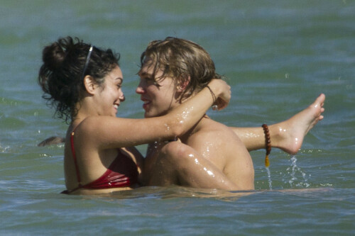 Back in each other's arms! Bikini-clad Vanessa Hudgens shares a steamy kiss with boyfriend Austin Butler as they are reunited in Hawaii

She's been promoting her latest movie Journey 2: The Mysterious Island, with her ex Josh Hutcherson and causing some confusion with the Australian press as to who's dating who.

But today, the bikini-clad 23-year-old was reunited with her current boyfriend Austin Butler in Hawaii, leaving onlookers with no doubt as to who has Vanessa 's heart now.

The couple, who have been dating since last September, are clearly very much in the honeymoon period of their relationship.

The High School Musical actress, who also dated co-star Zac Efron, looked stunning as she sported a tiny red string bikini in Hawaii.

She showed her athletic figure in the attire which she paired with some wooden-style jewellery accessories.

Vanessa and fellow Disney actor Austin, 20, frolicked in the ocean together, kissing and cuddling.

Their lovey-dovey behaviour akin to the last few weeks, with the couple just unable to keep their hands off each other.

When Vanessa and Austin started dating last year, friends said at the time that it was 'nothing serious', but the pair now seem to be inseparable.

They holidayed in Miami last month, visited Disneyland in Anaheim, California, and spent Christmas and New Year's together too.

Austin, who recently co-starred in the movie Sharpay's Fabulous Adventure, alongside Vanessa's best friend Ashley Tisdale, is three years younger than Vanessa.