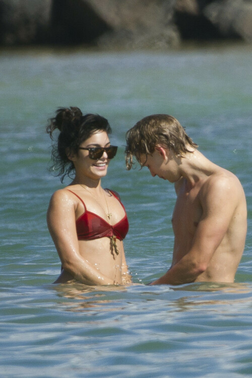 Back in each other's arms! Bikini-clad Vanessa Hudgens shares a steamy kiss with boyfriend Austin Butler as they are reunited in Hawaii

She's been promoting her latest movie Journey 2: The Mysterious Island, with her ex Josh Hutcherson and causing some confusion with the Australian press as to who's dating who.

But today, the bikini-clad 23-year-old was reunited with her current boyfriend Austin Butler in Hawaii, leaving onlookers with no doubt as to who has Vanessa 's heart now.

The couple, who have been dating since last September, are clearly very much in the honeymoon period of their relationship.

The High School Musical actress, who also dated co-star Zac Efron, looked stunning as she sported a tiny red string bikini in Hawaii.

She showed her athletic figure in the attire which she paired with some wooden-style jewellery accessories.

Vanessa and fellow Disney actor Austin, 20, frolicked in the ocean together, kissing and cuddling.

Their lovey-dovey behaviour akin to the last few weeks, with the couple just unable to keep their hands off each other.

When Vanessa and Austin started dating last year, friends said at the time that it was 'nothing serious', but the pair now seem to be inseparable.

They holidayed in Miami last month, visited Disneyland in Anaheim, California, and spent Christmas and New Year's together too.

Austin, who recently co-starred in the movie Sharpay's Fabulous Adventure, alongside Vanessa's best friend Ashley Tisdale, is three years younger than Vanessa.