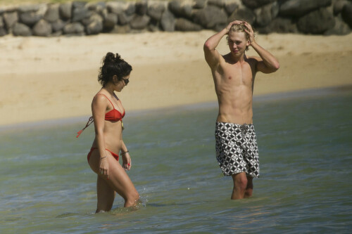 Back in each other's arms! Bikini-clad Vanessa Hudgens shares a steamy kiss with boyfriend Austin Butler as they are reunited in Hawaii

She's been promoting her latest movie Journey 2: The Mysterious Island, with her ex Josh Hutcherson and causing some confusion with the Australian press as to who's dating who.

But today, the bikini-clad 23-year-old was reunited with her current boyfriend Austin Butler in Hawaii, leaving onlookers with no doubt as to who has Vanessa 's heart now.

The couple, who have been dating since last September, are clearly very much in the honeymoon period of their relationship.

The High School Musical actress, who also dated co-star Zac Efron, looked stunning as she sported a tiny red string bikini in Hawaii.

She showed her athletic figure in the attire which she paired with some wooden-style jewellery accessories.

Vanessa and fellow Disney actor Austin, 20, frolicked in the ocean together, kissing and cuddling.

Their lovey-dovey behaviour akin to the last few weeks, with the couple just unable to keep their hands off each other.

When Vanessa and Austin started dating last year, friends said at the time that it was 'nothing serious', but the pair now seem to be inseparable.

They holidayed in Miami last month, visited Disneyland in Anaheim, California, and spent Christmas and New Year's together too.

Austin, who recently co-starred in the movie Sharpay's Fabulous Adventure, alongside Vanessa's best friend Ashley Tisdale, is three years younger than Vanessa.