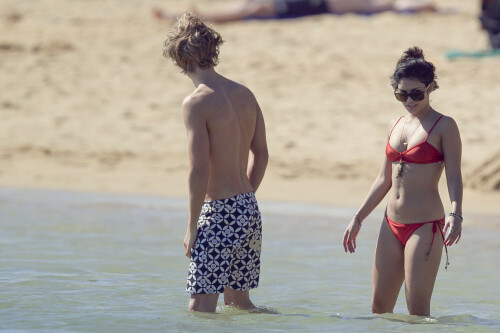 Back in each other's arms! Bikini-clad Vanessa Hudgens shares a steamy kiss with boyfriend Austin Butler as they are reunited in Hawaii

She's been promoting her latest movie Journey 2: The Mysterious Island, with her ex Josh Hutcherson and causing some confusion with the Australian press as to who's dating who.

But today, the bikini-clad 23-year-old was reunited with her current boyfriend Austin Butler in Hawaii, leaving onlookers with no doubt as to who has Vanessa 's heart now.

The couple, who have been dating since last September, are clearly very much in the honeymoon period of their relationship.

The High School Musical actress, who also dated co-star Zac Efron, looked stunning as she sported a tiny red string bikini in Hawaii.

She showed her athletic figure in the attire which she paired with some wooden-style jewellery accessories.

Vanessa and fellow Disney actor Austin, 20, frolicked in the ocean together, kissing and cuddling.

Their lovey-dovey behaviour akin to the last few weeks, with the couple just unable to keep their hands off each other.

When Vanessa and Austin started dating last year, friends said at the time that it was 'nothing serious', but the pair now seem to be inseparable.

They holidayed in Miami last month, visited Disneyland in Anaheim, California, and spent Christmas and New Year's together too.

Austin, who recently co-starred in the movie Sharpay's Fabulous Adventure, alongside Vanessa's best friend Ashley Tisdale, is three years younger than Vanessa.