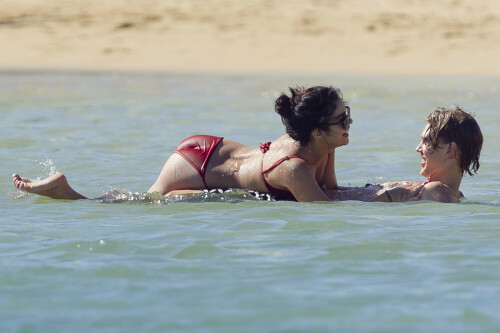 Back in each other's arms! Bikini-clad Vanessa Hudgens shares a steamy kiss with boyfriend Austin Butler as they are reunited in Hawaii

She's been promoting her latest movie Journey 2: The Mysterious Island, with her ex Josh Hutcherson and causing some confusion with the Australian press as to who's dating who.

But today, the bikini-clad 23-year-old was reunited with her current boyfriend Austin Butler in Hawaii, leaving onlookers with no doubt as to who has Vanessa 's heart now.

The couple, who have been dating since last September, are clearly very much in the honeymoon period of their relationship.

The High School Musical actress, who also dated co-star Zac Efron, looked stunning as she sported a tiny red string bikini in Hawaii.

She showed her athletic figure in the attire which she paired with some wooden-style jewellery accessories.

Vanessa and fellow Disney actor Austin, 20, frolicked in the ocean together, kissing and cuddling.

Their lovey-dovey behaviour akin to the last few weeks, with the couple just unable to keep their hands off each other.

When Vanessa and Austin started dating last year, friends said at the time that it was 'nothing serious', but the pair now seem to be inseparable.

They holidayed in Miami last month, visited Disneyland in Anaheim, California, and spent Christmas and New Year's together too.

Austin, who recently co-starred in the movie Sharpay's Fabulous Adventure, alongside Vanessa's best friend Ashley Tisdale, is three years younger than Vanessa.