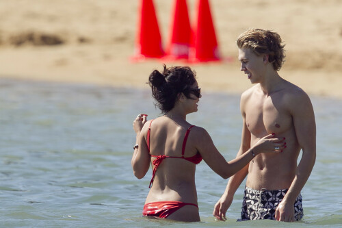 Back in each other's arms! Bikini-clad Vanessa Hudgens shares a steamy kiss with boyfriend Austin Butler as they are reunited in Hawaii

She's been promoting her latest movie Journey 2: The Mysterious Island, with her ex Josh Hutcherson and causing some confusion with the Australian press as to who's dating who.

But today, the bikini-clad 23-year-old was reunited with her current boyfriend Austin Butler in Hawaii, leaving onlookers with no doubt as to who has Vanessa 's heart now.

The couple, who have been dating since last September, are clearly very much in the honeymoon period of their relationship.

The High School Musical actress, who also dated co-star Zac Efron, looked stunning as she sported a tiny red string bikini in Hawaii.

She showed her athletic figure in the attire which she paired with some wooden-style jewellery accessories.

Vanessa and fellow Disney actor Austin, 20, frolicked in the ocean together, kissing and cuddling.

Their lovey-dovey behaviour akin to the last few weeks, with the couple just unable to keep their hands off each other.

When Vanessa and Austin started dating last year, friends said at the time that it was 'nothing serious', but the pair now seem to be inseparable.

They holidayed in Miami last month, visited Disneyland in Anaheim, California, and spent Christmas and New Year's together too.

Austin, who recently co-starred in the movie Sharpay's Fabulous Adventure, alongside Vanessa's best friend Ashley Tisdale, is three years younger than Vanessa.