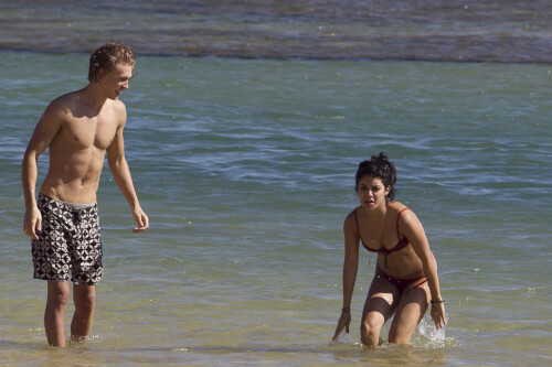 Back in each other's arms! Bikini-clad Vanessa Hudgens shares a steamy kiss with boyfriend Austin Butler as they are reunited in Hawaii

She's been promoting her latest movie Journey 2: The Mysterious Island, with her ex Josh Hutcherson and causing some confusion with the Australian press as to who's dating who.

But today, the bikini-clad 23-year-old was reunited with her current boyfriend Austin Butler in Hawaii, leaving onlookers with no doubt as to who has Vanessa 's heart now.

The couple, who have been dating since last September, are clearly very much in the honeymoon period of their relationship.

The High School Musical actress, who also dated co-star Zac Efron, looked stunning as she sported a tiny red string bikini in Hawaii.

She showed her athletic figure in the attire which she paired with some wooden-style jewellery accessories.

Vanessa and fellow Disney actor Austin, 20, frolicked in the ocean together, kissing and cuddling.

Their lovey-dovey behaviour akin to the last few weeks, with the couple just unable to keep their hands off each other.

When Vanessa and Austin started dating last year, friends said at the time that it was 'nothing serious', but the pair now seem to be inseparable.

They holidayed in Miami last month, visited Disneyland in Anaheim, California, and spent Christmas and New Year's together too.

Austin, who recently co-starred in the movie Sharpay's Fabulous Adventure, alongside Vanessa's best friend Ashley Tisdale, is three years younger than Vanessa.