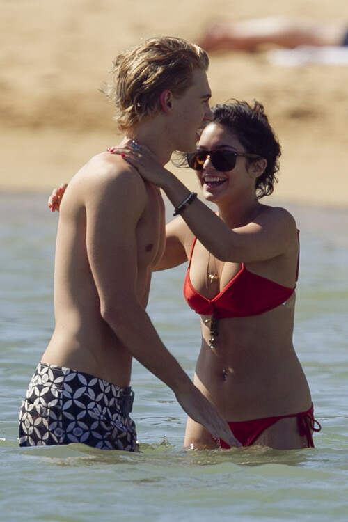 Back in each other's arms! Bikini-clad Vanessa Hudgens shares a steamy kiss with boyfriend Austin Butler as they are reunited in Hawaii

She's been promoting her latest movie Journey 2: The Mysterious Island, with her ex Josh Hutcherson and causing some confusion with the Australian press as to who's dating who.

But today, the bikini-clad 23-year-old was reunited with her current boyfriend Austin Butler in Hawaii, leaving onlookers with no doubt as to who has Vanessa 's heart now.

The couple, who have been dating since last September, are clearly very much in the honeymoon period of their relationship.

The High School Musical actress, who also dated co-star Zac Efron, looked stunning as she sported a tiny red string bikini in Hawaii.

She showed her athletic figure in the attire which she paired with some wooden-style jewellery accessories.

Vanessa and fellow Disney actor Austin, 20, frolicked in the ocean together, kissing and cuddling.

Their lovey-dovey behaviour akin to the last few weeks, with the couple just unable to keep their hands off each other.

When Vanessa and Austin started dating last year, friends said at the time that it was 'nothing serious', but the pair now seem to be inseparable.

They holidayed in Miami last month, visited Disneyland in Anaheim, California, and spent Christmas and New Year's together too.

Austin, who recently co-starred in the movie Sharpay's Fabulous Adventure, alongside Vanessa's best friend Ashley Tisdale, is three years younger than Vanessa.