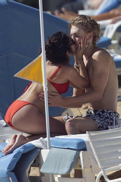 Back in each other's arms! Bikini-clad Vanessa Hudgens shares a steamy kiss with boyfriend Austin Butler as they are reunited in Hawaii

She's been promoting her latest movie Journey 2: The Mysterious Island, with her ex Josh Hutcherson and causing some confusion with the Australian press as to who's dating who.

But today, the bikini-clad 23-year-old was reunited with her current boyfriend Austin Butler in Hawaii, leaving onlookers with no doubt as to who has Vanessa 's heart now.

The couple, who have been dating since last September, are clearly very much in the honeymoon period of their relationship.

The High School Musical actress, who also dated co-star Zac Efron, looked stunning as she sported a tiny red string bikini in Hawaii.

She showed her athletic figure in the attire which she paired with some wooden-style jewellery accessories.

Vanessa and fellow Disney actor Austin, 20, frolicked in the ocean together, kissing and cuddling.

Their lovey-dovey behaviour akin to the last few weeks, with the couple just unable to keep their hands off each other.

When Vanessa and Austin started dating last year, friends said at the time that it was 'nothing serious', but the pair now seem to be inseparable.

They holidayed in Miami last month, visited Disneyland in Anaheim, California, and spent Christmas and New Year's together too.

Austin, who recently co-starred in the movie Sharpay's Fabulous Adventure, alongside Vanessa's best friend Ashley Tisdale, is three years younger than Vanessa.