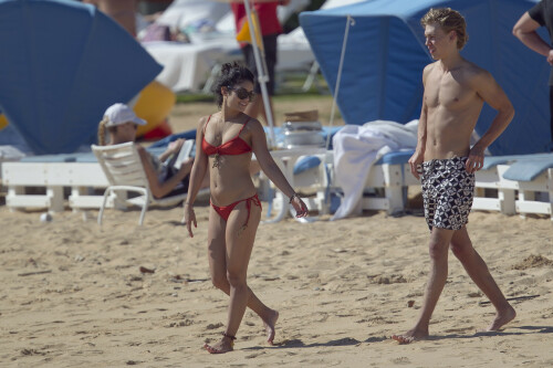 Back in each other's arms! Bikini-clad Vanessa Hudgens shares a steamy kiss with boyfriend Austin Butler as they are reunited in Hawaii

She's been promoting her latest movie Journey 2: The Mysterious Island, with her ex Josh Hutcherson and causing some confusion with the Australian press as to who's dating who.

But today, the bikini-clad 23-year-old was reunited with her current boyfriend Austin Butler in Hawaii, leaving onlookers with no doubt as to who has Vanessa 's heart now.

The couple, who have been dating since last September, are clearly very much in the honeymoon period of their relationship.

The High School Musical actress, who also dated co-star Zac Efron, looked stunning as she sported a tiny red string bikini in Hawaii.

She showed her athletic figure in the attire which she paired with some wooden-style jewellery accessories.

Vanessa and fellow Disney actor Austin, 20, frolicked in the ocean together, kissing and cuddling.

Their lovey-dovey behaviour akin to the last few weeks, with the couple just unable to keep their hands off each other.

When Vanessa and Austin started dating last year, friends said at the time that it was 'nothing serious', but the pair now seem to be inseparable.

They holidayed in Miami last month, visited Disneyland in Anaheim, California, and spent Christmas and New Year's together too.

Austin, who recently co-starred in the movie Sharpay's Fabulous Adventure, alongside Vanessa's best friend Ashley Tisdale, is three years younger than Vanessa.