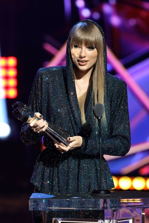 Taylor Swift - 2023 iHeartRadio Music Awards at Dolby Theatre in Hollywood - March 27, 2023

Taylor Swift sports sparkling jumpsuit at iHeartRadio Music Awards 2023

She’s in her innovator era.

Taylor Swift took a break from her Eras Tour to attend Monday night’s iHeartRadio Music Awards 2023, where she’s set to be honored with the Innovator Award during the ceremony.

And while she skipped the red carpet, the pop superstar popped up inside the ceremony, clad in a crystal-covered hooded jacket, pants and boots from Alexandre Vauthier Couture that lent the look of a jumpsuit (and could’ve been plucked straight from her “Reputation” era).

Swift wore her hair sleek and straight, completing her futuristic fashion moment with a silvery smoky eye, glossy nude lip and iridescent manicure, along with jewelry from KatKim and Anita Ko.

Per iHeartRadio’s press release, the Innovator Award is bestowed on an artist who has “impacted global pop culture throughout their career.”

Past recipients include Justin Timberlake, Pharrell Williams, U2, Bruno Mars, Chance the Rapper and Alicia Keys.

Phoebe Bridgers, Swift’s “Nothing New” collaborator and one of the opening acts on her Eras Tour, introduced her during the telecast.

Artists including Ed Sheeran, Selena Gomez, Justin Timberlake and Dolly Parton also spoke about her work and impact on the music industry in a video tribute that played before she took the stage to accept the honor.

Swift is among the night’s most nominated artists.

She’s up for a total of seven awards: Song of the Year, Best Lyrics and Best Music Video (all for “Anti-Hero”), TikTok Bop of the Year (“Bejeweled”), Favorite Use of a Sample (“Question…?”), Best Fan Army and Artist of the Year.

“I think the coolest ideas, motivations or choices are the ones that set a new precedent,” Swift said during her acceptance speech.

While she’s not scheduled to perform during the Lenny Kravitz-hosted ceremony, viewers can look forward to seeing Pink (who’s receiving the Icon Award), Kelly Clarkson, Keith Urban, Latto, Coldplay and Pat Benatar take the stage, among others.