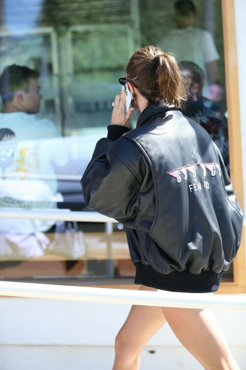 Hailey Bieber Embraces Lux Leather With Oversized Jacket & Metallic Nike Sneakers

Hailey Bieber was spotted grabbing a matcha drink while out in Los Angeles on Tuesday.

The 26-year-old model was photographed wearing a black waffle knit t-shirt underneath a black leather bomber jacket. She paired the top with white short shorts.

Bieber accessorized the neutral look with minimal jewelry opting solely for a pair of sparkling mini-gold hoops. She also added black vintage-style oval sunglasses. The model kept her warm blond hair in a sleek pulled-back style complimenting her minimal makeup that featured a mauve lip.

The Tiffany & Co. ambassador completed the look by slipping into a pair of white ankle socks and silver Nike Air Max sneakers. The metallic sneakers featured a wavy side paneled look with a beige tone lining the back of the chunky white sole and a black mesh encompassing the lace-up closure which was also decorated with a crisscross cord design.

The sneakers had a reflective finish completed with Nike’s Air cushioning to provide a lightweight experience The sneakers were designed by Sergio Lozano who pulled inspiration from retro athleisure wear from the 90s.

Bieber was just seen wearing these shoes while out in West Hollywood, Calif., earlier this week. During the recent sighting, the model embraced Y2K style as she paired the low-top sneakers with an oversized Martine Rose colorblock sports jacket and a distressed denim micro-mini skirt.

The model is known for her effortlessly chic style. When she’s spending a casual day to herself, you will usually see Bieber wearing a pair of sneakers or furry designer slides. If she’s making a red carpet appearance, Bieber is usually seen in textured pumps or strappy heels. Her shoe closet is filled with affordable sneakers from Nike, New Balance, or Reebok and luxury styles from Tabitha Simmons, Jimmy Choo and Prada.