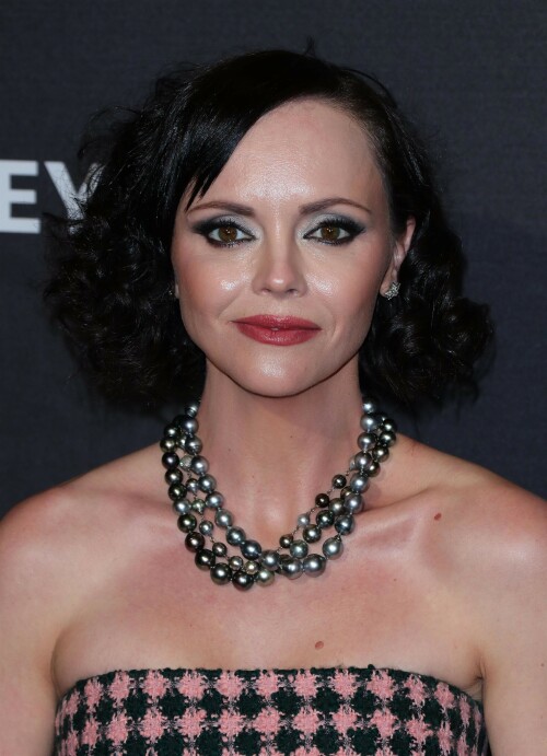 Actress Christina Ricci attends PaleyFest LA 2023 - 'Yellowjackets' at Dolby Theatre in Hollywood, California - April 3, 2023

Christina Ricci Goes Black and Pink in Strapless Jumpsuit at ‘Yellowjackets’ PaleyFest ScreeningThe actress is continuing to promote the second season of her hit Showtime series.

Christina Ricci arrived on the red carpet for the PaleyFest screening of her hit Showtime series “Yellowjackets” on Monday in Los Angeles.

The actress wore a black and pink-patterned jumpsuit. She paired the strapless piece with pointy-toe black platform heels and accessorized with a pair of pearl necklaces.

Ricci regularly works with celebrity stylist Cristina Ehrlich, who also works with Allison Williams, Hannah Waddingham and Trinity Bliss.

On March 22, Ricci attended the world premiere of “Yellowjackets” season two wearing a sleeveless black dress with a high neckline from Fendi. On March 14, for her appearance on “The Late Show With Stephen Colbert,” she wore a sleeveless black dress with side ruching on the skirt from Wolk Morais.

Ricci first came to fame as a child actress when she starred as Wednesday Addams in the 1991 film “The Addams Family” and its 1993 sequel “Addams Family Values.” Ricci returned to the “Addams Family” universe for “Wednesday,” playing the character Marilyn Thornhill. The series became the second most-watched English language Netflix series.

In November, she attended the “Wednesday” premiere wearing a sleeveless black gown with a sheer bodice, ruffle trims around the neckline and shoulders, a tiered skirt and a spiderweb pattern embroidered into the bodice from Rodarte.

Showtime drama “Yellowjackets” chronicles the lives of former teen soccer players who previously lived in the wilderness for 19 months. A hit upon its 2021 release, the program’s second season premiered on March 26. Stars include Ricci, Juliette Lewis, Melanie Lynskey, Tawny Cypress, Jasmin Savoy Brown and Steven Krueger, while new cast members include Elijah Wood, Simone Kessell and Lauren Ambrose.