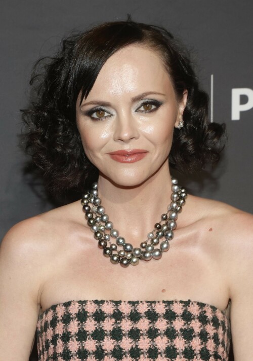 Actress Christina Ricci attends PaleyFest LA 2023 - 'Yellowjackets' at Dolby Theatre in Hollywood, California - April 3, 2023

Christina Ricci Goes Black and Pink in Strapless Jumpsuit at ‘Yellowjackets’ PaleyFest ScreeningThe actress is continuing to promote the second season of her hit Showtime series.

Christina Ricci arrived on the red carpet for the PaleyFest screening of her hit Showtime series “Yellowjackets” on Monday in Los Angeles.

The actress wore a black and pink-patterned jumpsuit. She paired the strapless piece with pointy-toe black platform heels and accessorized with a pair of pearl necklaces.

Ricci regularly works with celebrity stylist Cristina Ehrlich, who also works with Allison Williams, Hannah Waddingham and Trinity Bliss.

On March 22, Ricci attended the world premiere of “Yellowjackets” season two wearing a sleeveless black dress with a high neckline from Fendi. On March 14, for her appearance on “The Late Show With Stephen Colbert,” she wore a sleeveless black dress with side ruching on the skirt from Wolk Morais.

Ricci first came to fame as a child actress when she starred as Wednesday Addams in the 1991 film “The Addams Family” and its 1993 sequel “Addams Family Values.” Ricci returned to the “Addams Family” universe for “Wednesday,” playing the character Marilyn Thornhill. The series became the second most-watched English language Netflix series.

In November, she attended the “Wednesday” premiere wearing a sleeveless black gown with a sheer bodice, ruffle trims around the neckline and shoulders, a tiered skirt and a spiderweb pattern embroidered into the bodice from Rodarte.

Showtime drama “Yellowjackets” chronicles the lives of former teen soccer players who previously lived in the wilderness for 19 months. A hit upon its 2021 release, the program’s second season premiered on March 26. Stars include Ricci, Juliette Lewis, Melanie Lynskey, Tawny Cypress, Jasmin Savoy Brown and Steven Krueger, while new cast members include Elijah Wood, Simone Kessell and Lauren Ambrose.