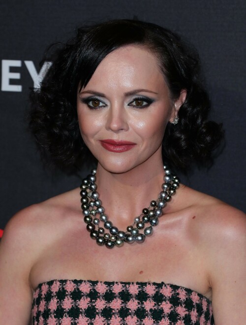 Actress Christina Ricci attends PaleyFest LA 2023 - 'Yellowjackets' at Dolby Theatre in Hollywood, California - April 3, 2023

Christina Ricci Goes Black and Pink in Strapless Jumpsuit at ‘Yellowjackets’ PaleyFest ScreeningThe actress is continuing to promote the second season of her hit Showtime series.

Christina Ricci arrived on the red carpet for the PaleyFest screening of her hit Showtime series “Yellowjackets” on Monday in Los Angeles.

The actress wore a black and pink-patterned jumpsuit. She paired the strapless piece with pointy-toe black platform heels and accessorized with a pair of pearl necklaces.

Ricci regularly works with celebrity stylist Cristina Ehrlich, who also works with Allison Williams, Hannah Waddingham and Trinity Bliss.

On March 22, Ricci attended the world premiere of “Yellowjackets” season two wearing a sleeveless black dress with a high neckline from Fendi. On March 14, for her appearance on “The Late Show With Stephen Colbert,” she wore a sleeveless black dress with side ruching on the skirt from Wolk Morais.

Ricci first came to fame as a child actress when she starred as Wednesday Addams in the 1991 film “The Addams Family” and its 1993 sequel “Addams Family Values.” Ricci returned to the “Addams Family” universe for “Wednesday,” playing the character Marilyn Thornhill. The series became the second most-watched English language Netflix series.

In November, she attended the “Wednesday” premiere wearing a sleeveless black gown with a sheer bodice, ruffle trims around the neckline and shoulders, a tiered skirt and a spiderweb pattern embroidered into the bodice from Rodarte.

Showtime drama “Yellowjackets” chronicles the lives of former teen soccer players who previously lived in the wilderness for 19 months. A hit upon its 2021 release, the program’s second season premiered on March 26. Stars include Ricci, Juliette Lewis, Melanie Lynskey, Tawny Cypress, Jasmin Savoy Brown and Steven Krueger, while new cast members include Elijah Wood, Simone Kessell and Lauren Ambrose.