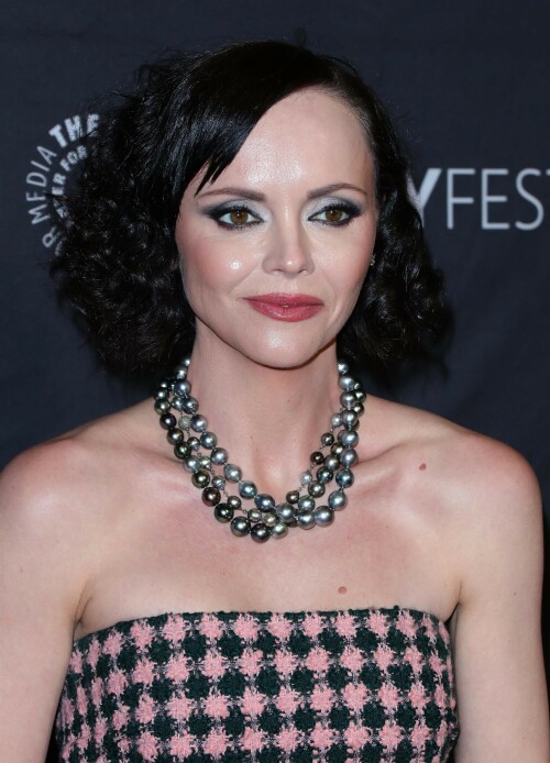 Actress Christina Ricci attends PaleyFest LA 2023 - 'Yellowjackets' at Dolby Theatre in Hollywood, California - April 3, 2023

Christina Ricci Goes Black and Pink in Strapless Jumpsuit at ‘Yellowjackets’ PaleyFest ScreeningThe actress is continuing to promote the second season of her hit Showtime series.

Christina Ricci arrived on the red carpet for the PaleyFest screening of her hit Showtime series “Yellowjackets” on Monday in Los Angeles.

The actress wore a black and pink-patterned jumpsuit. She paired the strapless piece with pointy-toe black platform heels and accessorized with a pair of pearl necklaces.

Ricci regularly works with celebrity stylist Cristina Ehrlich, who also works with Allison Williams, Hannah Waddingham and Trinity Bliss.

On March 22, Ricci attended the world premiere of “Yellowjackets” season two wearing a sleeveless black dress with a high neckline from Fendi. On March 14, for her appearance on “The Late Show With Stephen Colbert,” she wore a sleeveless black dress with side ruching on the skirt from Wolk Morais.

Ricci first came to fame as a child actress when she starred as Wednesday Addams in the 1991 film “The Addams Family” and its 1993 sequel “Addams Family Values.” Ricci returned to the “Addams Family” universe for “Wednesday,” playing the character Marilyn Thornhill. The series became the second most-watched English language Netflix series.

In November, she attended the “Wednesday” premiere wearing a sleeveless black gown with a sheer bodice, ruffle trims around the neckline and shoulders, a tiered skirt and a spiderweb pattern embroidered into the bodice from Rodarte.

Showtime drama “Yellowjackets” chronicles the lives of former teen soccer players who previously lived in the wilderness for 19 months. A hit upon its 2021 release, the program’s second season premiered on March 26. Stars include Ricci, Juliette Lewis, Melanie Lynskey, Tawny Cypress, Jasmin Savoy Brown and Steven Krueger, while new cast members include Elijah Wood, Simone Kessell and Lauren Ambrose.