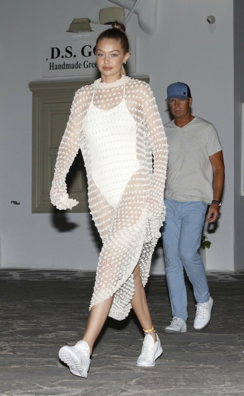 Gigi Hadid Full Fashion In White Dress In Mykonos, Greece - June 29, 2018

Gigi Hadid Celebrity Style: The Row Fairy Crocheted Silk-Blend Gown, Reebok Classic Leather Patent Sneakers in White and Solid & Striped the Lindsay One-Piece