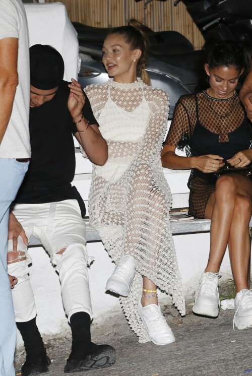 Gigi Hadid Full Fashion In White Dress In Mykonos, Greece - June 29, 2018

Gigi Hadid Celebrity Style: The Row Fairy Crocheted Silk-Blend Gown, Reebok Classic Leather Patent Sneakers in White and Solid & Striped the Lindsay One-Piece