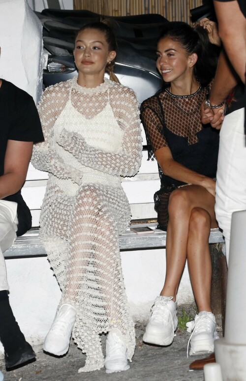 Gigi Hadid Full Fashion In White Dress In Mykonos, Greece - June 29, 2018

Gigi Hadid Celebrity Style: The Row Fairy Crocheted Silk-Blend Gown, Reebok Classic Leather Patent Sneakers in White and Solid & Striped the Lindsay One-Piece