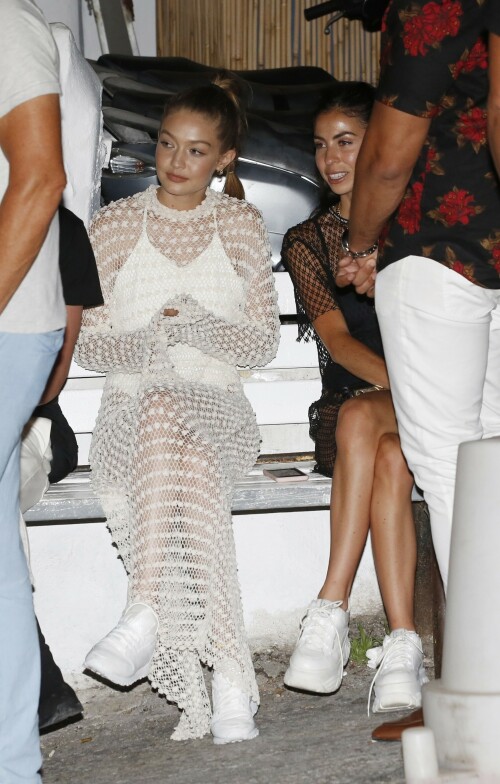 Gigi Hadid Full Fashion In White Dress In Mykonos, Greece - June 29, 2018

Gigi Hadid Celebrity Style: The Row Fairy Crocheted Silk-Blend Gown, Reebok Classic Leather Patent Sneakers in White and Solid & Striped the Lindsay One-Piece