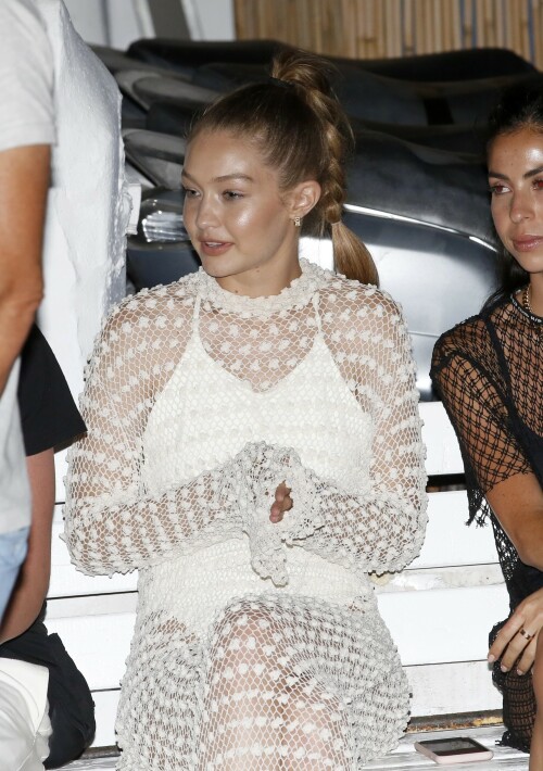 Gigi Hadid Full Fashion In White Dress In Mykonos, Greece - June 29, 2018

Gigi Hadid Celebrity Style: The Row Fairy Crocheted Silk-Blend Gown, Reebok Classic Leather Patent Sneakers in White and Solid & Striped the Lindsay One-Piece