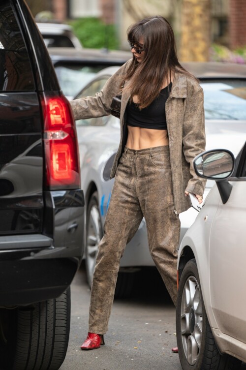 Emily Ratajkowski flashes her toned abs in a crop top paired with scarlet animal-print boots as she steps out in NYC - April 11, 2023

Emily Ratajkowski flashes her toned abs in a crop top paired with scarlet animal-print boots as she steps out in NYC - amid new Harry Styles romance

Emily Ratajkowski commanded attention on Tuesday as she stepped out in an eye-catching look in New York City amid her new romance with Harry Styles.

The 31-year-old supermodel — who was spotted with her son Sly on Monday — strutted her stuff in a plunging black crop top that exposed her enviable abs.

The mother-of-one wore a textured brown co-ord consisting of a jacket and matching trousers.

She teamed the fashion-forward look with a pair of bright, red, square-toed boots with a snake print design.

The High/Low With Emrata podcast host elevated the ensemble with a pair of lightly-tinted, narrow sunglasses with a black frame.

Emily, who is is a New York Times Bestselling author thanks to her book My Body, wore her chocolate-brown locks loose.

Her lustrous strands fell over her chest as she rocked them in an imperfect center part and face-framing bangs.

She donned a gold and black chain link necklace, along with chunky, medium-sized gold hoop earrings.

The runway regular slung a small, dark handbag over her shoulder and showed off a full face of makeup.

Last month the doting mom took to Instagram to share outtakes from the little boy's Paw Patrol themed birthday bash.

Emily recently broke her silence on the passionate, public kiss she shared with pop star Harry Styles in Tokyo.

While speaking with the Los Angeles Times, the star commented on the viral kiss, stating, 'There’s a million insane, inaccurate things about my relationships [that are said].'

'I’m definitely still not thinking about guys,' she continued, adding, 'Although, yeah. You know, sometimes things just happen.'

Shortly after the kiss, a source had told The Sun, 'They aren’t hiding anything,' and that the two 'are enjoying getting to know each other.'

'Getting filmed kissing in Tokyo and then that footage being shared with the world wasn’t what either of them expected — but they aren’t hiding anything,' the person reiterated.

In March, Emily hinted at a possible romance with the British-born singer, although she did not disclose his name, when appearing on the podcast Going Mental With Eileen Kelly.

'I just started dating someone that I kinda like, so that feels different,' she dished. 'He's kinda great.'

In the LA Times interview, the star also revealed that she stopped going to networking parties, as they were filled with 'disgusting' middle-aged men.

Since her split from Sebastian last summer, Ratajkowski has been linked to celebrities such as Pete Davidson, comedian Eric Andre, and most recently Harry Styles.

Emily talked about how news of her divorce got out while on an episode of the podcast Forbidden Fruits with Julia Fox and Niki Takesh : 'I went to a party where it was just, like, every famous person in the world and I was, like, not wearing my ring, and it, like, spread by the end of the night and I had so much fun.

However, she acknowledged the difficulties of being in the public eye when it comes to her romantic life.

'I went to a basketball game with my girlfriend, who is friends with a guy who had an extra seat, and when I came back from halftime, we switched, I sat next to him, and there were, like, a million pictures, like, 'EmRata seen on a date with so and so,' she recalled, adding, 'Can I get a fucking break?'