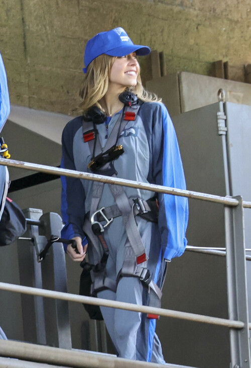 Euphoria Star Sydney Sweeney Spends Easter Holiday Climbing Sydney Harbour Bridge

Sydney Sweeney is currently shooting a new romantic comedy in Australia.

On Easter Sunday, the actress spent her day off climbing the Sydney Harbor Bridge alongside her co-star, Glen Powell, 34.

The Euphoria star shone as she took in the breathtaking view from far above the city.

The 25-year-old was decked out in a climbing suit in shades of gray and blue and a safety harness.

She completed her look with a baby cap and minimal make-up for the strenuous climb.

Sydney Sweeney is currently shooting a new romantic comedy in Australia

On Easter Sunday, the actress spent her day off climbing the Sydney Harbor Bridge alongside her co-star, Glen Powell

The Euphoria star shone as she took in the breathtaking view from far above the city

The beauty had her blonde locks around her face and a pair of headphones around her neck.

Glen opted for the same ensemble, with a classic climbing suit and matching blue cap.

Last month, the two took a break from filming to visit the Taronga Zoo together and feed giraffes.

Sydney has been Down Under for several weeks now and last week visited another popular tourist spot – Luna Park.

A guide led the actress up the many steps to the top of the bridge

She has filmed in locations around the city, including the inner-city suburb of Surry Hills and Double Bay, in the east of the city.

The yet-to-be-titled romantic comedy is directed by Will Gluck, who helmed the romantic comedies Easy A and Friends With Benefits.

Details about the plot of the R-rated movie are being kept under wraps, but the movie will also star Bryan Brown, Michelle Hurd, Hadley Robinson, and Darren Barnet.

The project is expected to bring in AUD$41 million to the local New South Wales economy and create more than 440 jobs for cast and crew.

Details about the plot of the R-rated movie are being kept under wraps, but the movie will also star Bryan Brown, Michelle Hurd, Hadley Robinson and Darren Barnet

The actress is best known for starring in The White Lotus and playing Cassie Howard on the HBO hit show Euphoria.

Sydney is engaged to Jonathan Davino, 37, a millionaire restaurant owner. The couple confirmed their engagement to People in March last year.

Sweeney and her fiancé were first spotted in each other’s company in 2018.

The actress made a rare statement about her love life during an interview with Cosmopolitan last year, saying she wasn’t romantically interested in anyone who works in the entertainment industry.

Maverick star Glen was spotted picking up his gorgeous model girlfriend Gigi Paris from the airport in Australia last month, while Gigi came to visit him on location

“I don’t date people who are in the spotlight. I don’t date actors or musicians or anyone in the entertainment business because that way I can just be normal Syd and it’s easiest. I have a great support system,” she said.

The artist did speak about the qualities she was looking for in a partner.

‘I’m looking for a best friend. I need to be able to be with someone who I can hang out with literally 24/7 and who I never tire of and who we laugh about every day,” she said.

Maverick star Glen was spotted last month picking up his gorgeous model girlfriend Gigi Paris from the airport in Australia, while Gigi came to visit him on location.