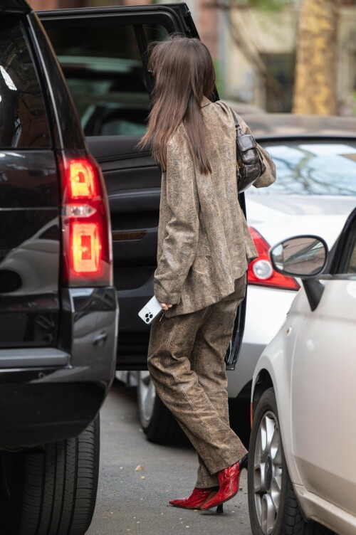 Emily Ratajkowski flashes her toned abs in a crop top paired with scarlet animal-print boots as she steps out in NYC - April 11, 2023

Emily Ratajkowski flashes her toned abs in a crop top paired with scarlet animal-print boots as she steps out in NYC - amid new Harry Styles romance

Emily Ratajkowski commanded attention on Tuesday as she stepped out in an eye-catching look in New York City amid her new romance with Harry Styles.

The 31-year-old supermodel — who was spotted with her son Sly on Monday — strutted her stuff in a plunging black crop top that exposed her enviable abs.

The mother-of-one wore a textured brown co-ord consisting of a jacket and matching trousers.

She teamed the fashion-forward look with a pair of bright, red, square-toed boots with a snake print design.

The High/Low With Emrata podcast host elevated the ensemble with a pair of lightly-tinted, narrow sunglasses with a black frame.

Emily, who is is a New York Times Bestselling author thanks to her book My Body, wore her chocolate-brown locks loose.

Her lustrous strands fell over her chest as she rocked them in an imperfect center part and face-framing bangs.

She donned a gold and black chain link necklace, along with chunky, medium-sized gold hoop earrings.

The runway regular slung a small, dark handbag over her shoulder and showed off a full face of makeup.

Last month the doting mom took to Instagram to share outtakes from the little boy's Paw Patrol themed birthday bash.

Emily recently broke her silence on the passionate, public kiss she shared with pop star Harry Styles in Tokyo.

While speaking with the Los Angeles Times, the star commented on the viral kiss, stating, 'There’s a million insane, inaccurate things about my relationships [that are said].'

'I’m definitely still not thinking about guys,' she continued, adding, 'Although, yeah. You know, sometimes things just happen.'

Shortly after the kiss, a source had told The Sun, 'They aren’t hiding anything,' and that the two 'are enjoying getting to know each other.'

'Getting filmed kissing in Tokyo and then that footage being shared with the world wasn’t what either of them expected — but they aren’t hiding anything,' the person reiterated.

In March, Emily hinted at a possible romance with the British-born singer, although she did not disclose his name, when appearing on the podcast Going Mental With Eileen Kelly.

'I just started dating someone that I kinda like, so that feels different,' she dished. 'He's kinda great.'

In the LA Times interview, the star also revealed that she stopped going to networking parties, as they were filled with 'disgusting' middle-aged men.

Since her split from Sebastian last summer, Ratajkowski has been linked to celebrities such as Pete Davidson, comedian Eric Andre, and most recently Harry Styles.

Emily talked about how news of her divorce got out while on an episode of the podcast Forbidden Fruits with Julia Fox and Niki Takesh : 'I went to a party where it was just, like, every famous person in the world and I was, like, not wearing my ring, and it, like, spread by the end of the night and I had so much fun.

However, she acknowledged the difficulties of being in the public eye when it comes to her romantic life.

'I went to a basketball game with my girlfriend, who is friends with a guy who had an extra seat, and when I came back from halftime, we switched, I sat next to him, and there were, like, a million pictures, like, 'EmRata seen on a date with so and so,' she recalled, adding, 'Can I get a fucking break?'