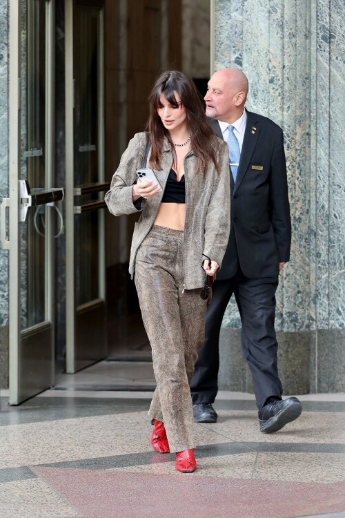 Emily Ratajkowski flashes her toned abs in a crop top paired with scarlet animal-print boots as she steps out in NYC - April 11, 2023

Emily Ratajkowski flashes her toned abs in a crop top paired with scarlet animal-print boots as she steps out in NYC - amid new Harry Styles romance

Emily Ratajkowski commanded attention on Tuesday as she stepped out in an eye-catching look in New York City amid her new romance with Harry Styles.

The 31-year-old supermodel — who was spotted with her son Sly on Monday — strutted her stuff in a plunging black crop top that exposed her enviable abs.

The mother-of-one wore a textured brown co-ord consisting of a jacket and matching trousers.

She teamed the fashion-forward look with a pair of bright, red, square-toed boots with a snake print design.

The High/Low With Emrata podcast host elevated the ensemble with a pair of lightly-tinted, narrow sunglasses with a black frame.

Emily, who is is a New York Times Bestselling author thanks to her book My Body, wore her chocolate-brown locks loose.

Her lustrous strands fell over her chest as she rocked them in an imperfect center part and face-framing bangs.

She donned a gold and black chain link necklace, along with chunky, medium-sized gold hoop earrings.

The runway regular slung a small, dark handbag over her shoulder and showed off a full face of makeup.

Last month the doting mom took to Instagram to share outtakes from the little boy's Paw Patrol themed birthday bash.

Emily recently broke her silence on the passionate, public kiss she shared with pop star Harry Styles in Tokyo.

While speaking with the Los Angeles Times, the star commented on the viral kiss, stating, 'There’s a million insane, inaccurate things about my relationships [that are said].'

'I’m definitely still not thinking about guys,' she continued, adding, 'Although, yeah. You know, sometimes things just happen.'

Shortly after the kiss, a source had told The Sun, 'They aren’t hiding anything,' and that the two 'are enjoying getting to know each other.'

'Getting filmed kissing in Tokyo and then that footage being shared with the world wasn’t what either of them expected — but they aren’t hiding anything,' the person reiterated.

In March, Emily hinted at a possible romance with the British-born singer, although she did not disclose his name, when appearing on the podcast Going Mental With Eileen Kelly.

'I just started dating someone that I kinda like, so that feels different,' she dished. 'He's kinda great.'

In the LA Times interview, the star also revealed that she stopped going to networking parties, as they were filled with 'disgusting' middle-aged men.

Since her split from Sebastian last summer, Ratajkowski has been linked to celebrities such as Pete Davidson, comedian Eric Andre, and most recently Harry Styles.

Emily talked about how news of her divorce got out while on an episode of the podcast Forbidden Fruits with Julia Fox and Niki Takesh : 'I went to a party where it was just, like, every famous person in the world and I was, like, not wearing my ring, and it, like, spread by the end of the night and I had so much fun.

However, she acknowledged the difficulties of being in the public eye when it comes to her romantic life.

'I went to a basketball game with my girlfriend, who is friends with a guy who had an extra seat, and when I came back from halftime, we switched, I sat next to him, and there were, like, a million pictures, like, 'EmRata seen on a date with so and so,' she recalled, adding, 'Can I get a fucking break?'