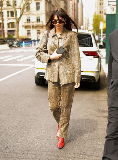 Emily Ratajkowski flashes her toned abs in a crop top paired with scarlet animal-print boots as she steps out in NYC - April 11, 2023

Emily Ratajkowski flashes her toned abs in a crop top paired with scarlet animal-print boots as she steps out in NYC - amid new Harry Styles romance

Emily Ratajkowski commanded attention on Tuesday as she stepped out in an eye-catching look in New York City amid her new romance with Harry Styles.

The 31-year-old supermodel — who was spotted with her son Sly on Monday — strutted her stuff in a plunging black crop top that exposed her enviable abs.

The mother-of-one wore a textured brown co-ord consisting of a jacket and matching trousers.

She teamed the fashion-forward look with a pair of bright, red, square-toed boots with a snake print design.

The High/Low With Emrata podcast host elevated the ensemble with a pair of lightly-tinted, narrow sunglasses with a black frame.

Emily, who is is a New York Times Bestselling author thanks to her book My Body, wore her chocolate-brown locks loose.

Her lustrous strands fell over her chest as she rocked them in an imperfect center part and face-framing bangs.

She donned a gold and black chain link necklace, along with chunky, medium-sized gold hoop earrings.

The runway regular slung a small, dark handbag over her shoulder and showed off a full face of makeup.

Last month the doting mom took to Instagram to share outtakes from the little boy's Paw Patrol themed birthday bash.

Emily recently broke her silence on the passionate, public kiss she shared with pop star Harry Styles in Tokyo.

While speaking with the Los Angeles Times, the star commented on the viral kiss, stating, 'There’s a million insane, inaccurate things about my relationships [that are said].'

'I’m definitely still not thinking about guys,' she continued, adding, 'Although, yeah. You know, sometimes things just happen.'

Shortly after the kiss, a source had told The Sun, 'They aren’t hiding anything,' and that the two 'are enjoying getting to know each other.'

'Getting filmed kissing in Tokyo and then that footage being shared with the world wasn’t what either of them expected — but they aren’t hiding anything,' the person reiterated.

In March, Emily hinted at a possible romance with the British-born singer, although she did not disclose his name, when appearing on the podcast Going Mental With Eileen Kelly.

'I just started dating someone that I kinda like, so that feels different,' she dished. 'He's kinda great.'

In the LA Times interview, the star also revealed that she stopped going to networking parties, as they were filled with 'disgusting' middle-aged men.

Since her split from Sebastian last summer, Ratajkowski has been linked to celebrities such as Pete Davidson, comedian Eric Andre, and most recently Harry Styles.

Emily talked about how news of her divorce got out while on an episode of the podcast Forbidden Fruits with Julia Fox and Niki Takesh : 'I went to a party where it was just, like, every famous person in the world and I was, like, not wearing my ring, and it, like, spread by the end of the night and I had so much fun.

However, she acknowledged the difficulties of being in the public eye when it comes to her romantic life.

'I went to a basketball game with my girlfriend, who is friends with a guy who had an extra seat, and when I came back from halftime, we switched, I sat next to him, and there were, like, a million pictures, like, 'EmRata seen on a date with so and so,' she recalled, adding, 'Can I get a fucking break?'