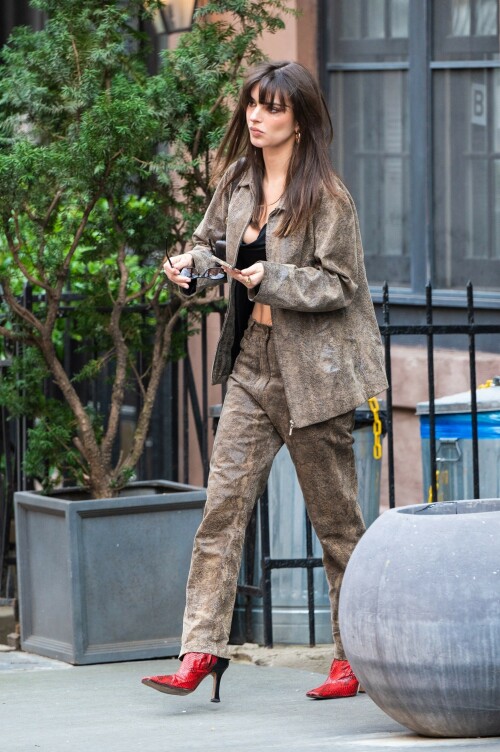 Emily Ratajkowski flashes her toned abs in a crop top paired with scarlet animal-print boots as she steps out in NYC - April 11, 2023

Emily Ratajkowski flashes her toned abs in a crop top paired with scarlet animal-print boots as she steps out in NYC - amid new Harry Styles romance

Emily Ratajkowski commanded attention on Tuesday as she stepped out in an eye-catching look in New York City amid her new romance with Harry Styles.

The 31-year-old supermodel — who was spotted with her son Sly on Monday — strutted her stuff in a plunging black crop top that exposed her enviable abs.

The mother-of-one wore a textured brown co-ord consisting of a jacket and matching trousers.

She teamed the fashion-forward look with a pair of bright, red, square-toed boots with a snake print design.

The High/Low With Emrata podcast host elevated the ensemble with a pair of lightly-tinted, narrow sunglasses with a black frame.

Emily, who is is a New York Times Bestselling author thanks to her book My Body, wore her chocolate-brown locks loose.

Her lustrous strands fell over her chest as she rocked them in an imperfect center part and face-framing bangs.

She donned a gold and black chain link necklace, along with chunky, medium-sized gold hoop earrings.

The runway regular slung a small, dark handbag over her shoulder and showed off a full face of makeup.

Last month the doting mom took to Instagram to share outtakes from the little boy's Paw Patrol themed birthday bash.

Emily recently broke her silence on the passionate, public kiss she shared with pop star Harry Styles in Tokyo.

While speaking with the Los Angeles Times, the star commented on the viral kiss, stating, 'There’s a million insane, inaccurate things about my relationships [that are said].'

'I’m definitely still not thinking about guys,' she continued, adding, 'Although, yeah. You know, sometimes things just happen.'

Shortly after the kiss, a source had told The Sun, 'They aren’t hiding anything,' and that the two 'are enjoying getting to know each other.'

'Getting filmed kissing in Tokyo and then that footage being shared with the world wasn’t what either of them expected — but they aren’t hiding anything,' the person reiterated.

In March, Emily hinted at a possible romance with the British-born singer, although she did not disclose his name, when appearing on the podcast Going Mental With Eileen Kelly.

'I just started dating someone that I kinda like, so that feels different,' she dished. 'He's kinda great.'

In the LA Times interview, the star also revealed that she stopped going to networking parties, as they were filled with 'disgusting' middle-aged men.

Since her split from Sebastian last summer, Ratajkowski has been linked to celebrities such as Pete Davidson, comedian Eric Andre, and most recently Harry Styles.

Emily talked about how news of her divorce got out while on an episode of the podcast Forbidden Fruits with Julia Fox and Niki Takesh : 'I went to a party where it was just, like, every famous person in the world and I was, like, not wearing my ring, and it, like, spread by the end of the night and I had so much fun.

However, she acknowledged the difficulties of being in the public eye when it comes to her romantic life.

'I went to a basketball game with my girlfriend, who is friends with a guy who had an extra seat, and when I came back from halftime, we switched, I sat next to him, and there were, like, a million pictures, like, 'EmRata seen on a date with so and so,' she recalled, adding, 'Can I get a fucking break?'