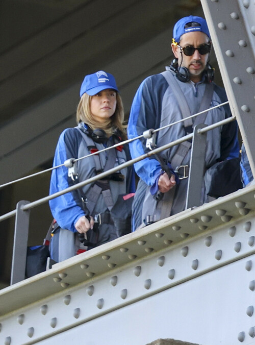 Euphoria Star Sydney Sweeney Spends Easter Holiday Climbing Sydney Harbour Bridge

Sydney Sweeney is currently shooting a new romantic comedy in Australia.

On Easter Sunday, the actress spent her day off climbing the Sydney Harbor Bridge alongside her co-star, Glen Powell, 34.

The Euphoria star shone as she took in the breathtaking view from far above the city.

The 25-year-old was decked out in a climbing suit in shades of gray and blue and a safety harness.

She completed her look with a baby cap and minimal make-up for the strenuous climb.

Sydney Sweeney is currently shooting a new romantic comedy in Australia

On Easter Sunday, the actress spent her day off climbing the Sydney Harbor Bridge alongside her co-star, Glen Powell

The Euphoria star shone as she took in the breathtaking view from far above the city

The beauty had her blonde locks around her face and a pair of headphones around her neck.

Glen opted for the same ensemble, with a classic climbing suit and matching blue cap.

Last month, the two took a break from filming to visit the Taronga Zoo together and feed giraffes.

Sydney has been Down Under for several weeks now and last week visited another popular tourist spot – Luna Park.

A guide led the actress up the many steps to the top of the bridge

She has filmed in locations around the city, including the inner-city suburb of Surry Hills and Double Bay, in the east of the city.

The yet-to-be-titled romantic comedy is directed by Will Gluck, who helmed the romantic comedies Easy A and Friends With Benefits.

Details about the plot of the R-rated movie are being kept under wraps, but the movie will also star Bryan Brown, Michelle Hurd, Hadley Robinson, and Darren Barnet.

The project is expected to bring in AUD$41 million to the local New South Wales economy and create more than 440 jobs for cast and crew.

Details about the plot of the R-rated movie are being kept under wraps, but the movie will also star Bryan Brown, Michelle Hurd, Hadley Robinson and Darren Barnet

The actress is best known for starring in The White Lotus and playing Cassie Howard on the HBO hit show Euphoria.

Sydney is engaged to Jonathan Davino, 37, a millionaire restaurant owner. The couple confirmed their engagement to People in March last year.

Sweeney and her fiancé were first spotted in each other’s company in 2018.

The actress made a rare statement about her love life during an interview with Cosmopolitan last year, saying she wasn’t romantically interested in anyone who works in the entertainment industry.

Maverick star Glen was spotted picking up his gorgeous model girlfriend Gigi Paris from the airport in Australia last month, while Gigi came to visit him on location

“I don’t date people who are in the spotlight. I don’t date actors or musicians or anyone in the entertainment business because that way I can just be normal Syd and it’s easiest. I have a great support system,” she said.

The artist did speak about the qualities she was looking for in a partner.

‘I’m looking for a best friend. I need to be able to be with someone who I can hang out with literally 24/7 and who I never tire of and who we laugh about every day,” she said.

Maverick star Glen was spotted last month picking up his gorgeous model girlfriend Gigi Paris from the airport in Australia, while Gigi came to visit him on location.