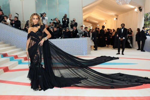 Met Gala 2023: Rita Ora Is Serving Fashion Witch at The Met Gala

May shmay! It's spooky season for Rita.

Fifty Shades of Grey actor Rita Ora arrived at the 2023 Met Gala in a witchy and bewitching gown that makes us feel incredibly October given that it's May. Is she vying for a part on her beau Taika Waititi's What We Do in the Shadows? Very much still in her boudoir fashion era. It's not not lingerie.

Ora's Prabal Gurung gown for the event plays with sheer and with layers, two elements she's been wearing a lot lately, but it's the nails and train that really stand out. Her long black…cloak? Cape? Scarf? covered nearly the length of the blue, white, and red carpet, creating a dramatic silhouette and, frankly, giving her a moment to get all camera lenses on her.

Equally decadent were the jewels literally dripping from her fingertips, as glittering ropes cascaded from her nails. Okay but like, how's she gonna eat dinner inside?

The smoky eye will never die. But combined with the lined lips? It's the new classics.

Ora reflected on the night's theme—"Karl Lagerfeld: A Line of Beauty"—on Instagram, sharing two posts in honor of the late designer. In the first, she and Lagerfeld pose together at various events, she walks the runway in a silver ensemble, and wears his designs for Chanel in various shoots.

In the second photo roundup, seemingly taken recently (peep the nails), Ora plays around in an old costume made by Karl himself. "In memory of Karl I had to bring back this custom piece he made me for a Chanel show performance I did with him in Monaco back in 2013. See you tomorrow!!" the singer wrote.

It's not that this doesn't go with the theme—the flowers and the black are totally Lagerfeldian—but anyone else think this is what she would have worn no matter what?

Rita Ora attends The 2023 Met Gala Celebrating "Karl Lagerfeld: A Line Of Beauty" at The Metropolitan Museum of Art on May 01, 2023 in New York City. 

Met Gala 2023: Rita Ora sizzles in a black sheer gown as she joins dapper husband Taika Waititi on the star-studded red carpet. 

Rita Ora brought the goth glamour to the Met Gala 2023 red carpet with a sheer corseted gown by Prabal Gurung.

#RitaOra #2023MetGala