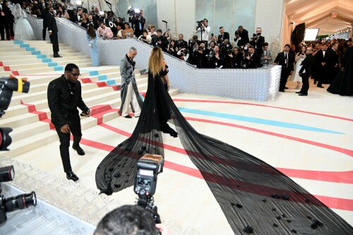 Rita Ora Makes a Case for Sheer on Met Gala Red Carpet 2023 in Prabal Gurung Dress & Strappy Sandals With Taika Waititi

Rita Ora arrived at the 2023 Met Gala in New York wearing an all-black ensemble. The singer posed on the carpet with her husband, director Taika Waititi.

Ora donned a daring outfit that featured detailed draping, striking cutouts and well-defined boning from Prabal Gurung.

The Nepalese-American fashion designer has been a fixture at the Met Gala since 2010. His designs have graced the red carpet, showcasing his signature style that often combines traditional Nepalese influences with modern, edgy elements. He has dressed a range of celebrities, from Sarah Jessica Parker to Zendaya over the years.

Regarding her footwear choice, Ora strapped on a pair of strappy sandals with a generous platform. These strappy platform sandals feature a chic ankle buckle closure that provides a secure fit. The almond toe design adds a touch of elegance, while the 6-inch heel elongates the legs and creates a flattering silhouette.

Ora’s fashion style is a mix of edgy and glamorous, often pushing boundaries with bold statement pieces. She is known for wearing daring outfits that showcase her confident and daring personality. Rita has also been a standout at the Met Gala, consistently impressing with her unique and avant-garde choices. From her bold silver feathered gown in 2016 to her Prada moment in 2021, she always manages to turn heads on the red carpet.

The Met Gala raises funds for the Metropolitan Museum of Art in New York City and celebrates the Costume Institute’s annual exhibits. This year’s theme, “Karl Lagerfeld: A Line of Beauty,” celebrates the life and career of designer Karl Lagerfeld. The 2023 event is notably co-chaired by Dua Lipa, Roger Federer, Michaela Coel, Penelope Cruz and Vogue editor-in-chief Anna Wintour.

Rita Ora attends The 2023 Met Gala Celebrating "Karl Lagerfeld: A Line Of Beauty" at The Metropolitan Museum of Art on May 01, 2023 in New York City.

Met Gala 2023: Rita Ora sizzles in a black sheer gown as she joins dapper husband Taika Waititi on the star-studded red carpet.

Rita Ora brought the goth glamour to the Met Gala 2023 red carpet with a sheer corseted gown by Prabal Gurung.

#RitaOra #2023MetGala