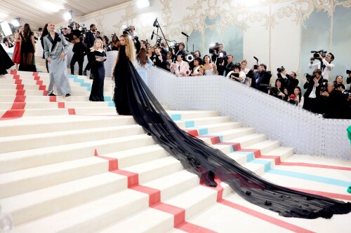 Met Gala 2023: Rita Ora Is Serving Fashion Witch at The Met Gala

May shmay! It's spooky season for Rita.

Fifty Shades of Grey actor Rita Ora arrived at the 2023 Met Gala in a witchy and bewitching gown that makes us feel incredibly October given that it's May. Is she vying for a part on her beau Taika Waititi's What We Do in the Shadows? Very much still in her boudoir fashion era. It's not not lingerie.

Ora's Prabal Gurung gown for the event plays with sheer and with layers, two elements she's been wearing a lot lately, but it's the nails and train that really stand out. Her long black…cloak? Cape? Scarf? covered nearly the length of the blue, white, and red carpet, creating a dramatic silhouette and, frankly, giving her a moment to get all camera lenses on her.

Equally decadent were the jewels literally dripping from her fingertips, as glittering ropes cascaded from her nails. Okay but like, how's she gonna eat dinner inside?

The smoky eye will never die. But combined with the lined lips? It's the new classics.

Ora reflected on the night's theme—"Karl Lagerfeld: A Line of Beauty"—on Instagram, sharing two posts in honor of the late designer. In the first, she and Lagerfeld pose together at various events, she walks the runway in a silver ensemble, and wears his designs for Chanel in various shoots.

In the second photo roundup, seemingly taken recently (peep the nails), Ora plays around in an old costume made by Karl himself. "In memory of Karl I had to bring back this custom piece he made me for a Chanel show performance I did with him in Monaco back in 2013. See you tomorrow!!" the singer wrote.

It's not that this doesn't go with the theme—the flowers and the black are totally Lagerfeldian—but anyone else think this is what she would have worn no matter what?

Rita Ora attends The 2023 Met Gala Celebrating "Karl Lagerfeld: A Line Of Beauty" at The Metropolitan Museum of Art on May 01, 2023 in New York City.

Met Gala 2023: Rita Ora sizzles in a black sheer gown as she joins dapper husband Taika Waititi on the star-studded red carpet.

Rita Ora brought the goth glamour to the Met Gala 2023 red carpet with a sheer corseted gown by Prabal Gurung.

#RitaOra #2023MetGala