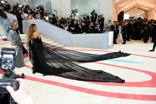 Rita Ora Makes a Case for Sheer on Met Gala Red Carpet 2023 in Prabal Gurung Dress & Strappy Sandals With Taika Waititi

Rita Ora arrived at the 2023 Met Gala in New York wearing an all-black ensemble. The singer posed on the carpet with her husband, director Taika Waititi.

Ora donned a daring outfit that featured detailed draping, striking cutouts and well-defined boning from Prabal Gurung.

The Nepalese-American fashion designer has been a fixture at the Met Gala since 2010. His designs have graced the red carpet, showcasing his signature style that often combines traditional Nepalese influences with modern, edgy elements. He has dressed a range of celebrities, from Sarah Jessica Parker to Zendaya over the years.

Regarding her footwear choice, Ora strapped on a pair of strappy sandals with a generous platform. These strappy platform sandals feature a chic ankle buckle closure that provides a secure fit. The almond toe design adds a touch of elegance, while the 6-inch heel elongates the legs and creates a flattering silhouette.

Ora’s fashion style is a mix of edgy and glamorous, often pushing boundaries with bold statement pieces. She is known for wearing daring outfits that showcase her confident and daring personality. Rita has also been a standout at the Met Gala, consistently impressing with her unique and avant-garde choices. From her bold silver feathered gown in 2016 to her Prada moment in 2021, she always manages to turn heads on the red carpet.

The Met Gala raises funds for the Metropolitan Museum of Art in New York City and celebrates the Costume Institute’s annual exhibits. This year’s theme, “Karl Lagerfeld: A Line of Beauty,” celebrates the life and career of designer Karl Lagerfeld. The 2023 event is notably co-chaired by Dua Lipa, Roger Federer, Michaela Coel, Penelope Cruz and Vogue editor-in-chief Anna Wintour.

Rita Ora attends The 2023 Met Gala Celebrating "Karl Lagerfeld: A Line Of Beauty" at The Metropolitan Museum of Art on May 01, 2023 in New York City.

Met Gala 2023: Rita Ora sizzles in a black sheer gown as she joins dapper husband Taika Waititi on the star-studded red carpet.

Rita Ora brought the goth glamour to the Met Gala 2023 red carpet with a sheer corseted gown by Prabal Gurung.

#RitaOra #2023MetGala