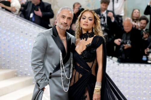 Rita Ora Makes a Case for Sheer on Met Gala Red Carpet 2023 in Prabal Gurung Dress & Strappy Sandals With Taika Waititi

Rita Ora arrived at the 2023 Met Gala in New York wearing an all-black ensemble. The singer posed on the carpet with her husband, director Taika Waititi.

Ora donned a daring outfit that featured detailed draping, striking cutouts and well-defined boning from Prabal Gurung.

The Nepalese-American fashion designer has been a fixture at the Met Gala since 2010. His designs have graced the red carpet, showcasing his signature style that often combines traditional Nepalese influences with modern, edgy elements. He has dressed a range of celebrities, from Sarah Jessica Parker to Zendaya over the years.

Regarding her footwear choice, Ora strapped on a pair of strappy sandals with a generous platform. These strappy platform sandals feature a chic ankle buckle closure that provides a secure fit. The almond toe design adds a touch of elegance, while the 6-inch heel elongates the legs and creates a flattering silhouette.

Ora’s fashion style is a mix of edgy and glamorous, often pushing boundaries with bold statement pieces. She is known for wearing daring outfits that showcase her confident and daring personality. Rita has also been a standout at the Met Gala, consistently impressing with her unique and avant-garde choices. From her bold silver feathered gown in 2016 to her Prada moment in 2021, she always manages to turn heads on the red carpet.

The Met Gala raises funds for the Metropolitan Museum of Art in New York City and celebrates the Costume Institute’s annual exhibits. This year’s theme, “Karl Lagerfeld: A Line of Beauty,” celebrates the life and career of designer Karl Lagerfeld. The 2023 event is notably co-chaired by Dua Lipa, Roger Federer, Michaela Coel, Penelope Cruz and Vogue editor-in-chief Anna Wintour.

Rita Ora attends The 2023 Met Gala Celebrating "Karl Lagerfeld: A Line Of Beauty" at The Metropolitan Museum of Art on May 01, 2023 in New York City.

Met Gala 2023: Rita Ora sizzles in a black sheer gown as she joins dapper husband Taika Waititi on the star-studded red carpet.

Rita Ora brought the goth glamour to the Met Gala 2023 red carpet with a sheer corseted gown by Prabal Gurung.

#RitaOra #2023MetGala