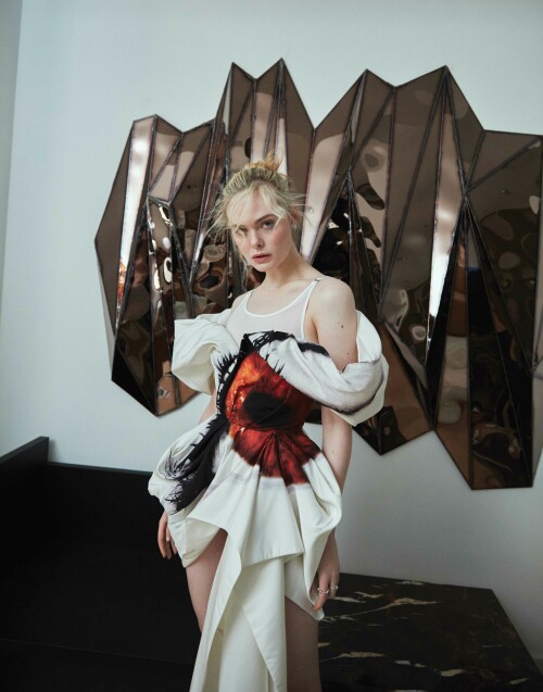 Elle Fanning Photoshoot for Flaunt Magazine 186: The Pomenade Issue, April 2023

Details: ALEXANDER MCQUEEN dress, ROGER VIVIER shoes, and CARTIER earrings, bracelet, and rings.
JULIAN MAYOR wall sculpture and VAUST chaise lounge.

ELLE FANNING | LET US COUNT THE WAYS: MISTAKE MAKING, MULTIFACETED, AND MAGNIFICENT

It’s a glorious spring day and one of the first where Los Angeles has seen sunshine in a while, after several unusually bleak winter months. Light beams in through tall, glass windows and onto actor, Elle Fanning, who is now back at home after finishing up a long stint in London filming season three of The Great—Hulu’s hit period drama in which she portrays eighteenth-century Russian empress, Catherine the Great. She’s excited to talk about the show from the get-go. “This season is probably full of the most twists, turns, and surprises yet,” she laughs, as the bright sunshine continues to pour into her home. “A lot of unexpected things are going to happen.”

The Great has proven to be a television phenomenon and a defining role for Fanning, who has been a constant presence in Hollywood since childhood. She’s appeared in films as varied as David Fincher’s The Curious Case of Benjamin Button, Nicolas Winding Refn’s The Neon Demon, J.J. Abrams’s Super 8, Sofia Coppola’s Somewhere and The Beguiled, as well as Disney’s Maleficent. When the script for The Great came her way, penned by The Favourite writer, Tony McNamara, she knew it had the potential to be a game-changing part.

“It was unlike anything I’d ever read before,” Fanning says of the script, as she pushes strands of her blonde hair back from her face, which is fashioned into a neat bun. She says she’s learned more about herself through depicting Catherine than in any of her other roles to date. “I’ve really seen myself in a different light playing this character. Like her, I’ve learned to trust my opinions, inklings, and instincts, and to listen to them as I much as I can, and I’m probably not as afraid to fail now because of what Catherine has taught me. She’s made me a stronger woman... I feel like I’ve grown as a woman getting to play such a powerful figure.”

Fanning is warm and gregarious to speak to: she’s passionate about her character, but also her profession and the rights and opportunities for women in the entertainment industry. Her answers are thoughtful but also funny, too—something that coincides with her character in The Great, flexing more comedic bones in the upcoming season. “I have been reflecting a lot on Catherine and myself and how our lives have intertwined,” she laughs, the sunlight reflecting off a delicate,pastel-lemon knit she is wearing. “We did the pilot when I was 20 and now, I’m about to turn 25. I’ve been on this show during the most formative years of my life and Catherine has become imprinted on my soul. I wonder if it’s her who’s helped me, or is it me who has just put so much of myself into her? I’m not sure,” she muses. “The lines are starting to blur a lot with the both of us. But it is the most special part I’ve ever had.”

Season three sees Catherine come into her own as a leader. Two seasons ago, she was an idealistic young bride whose hopes of a loving marriage were soon dashed when she was wedded to Emperor Peter (played by Nicholas Hoult), a wild, cheating husband, who is violent and misogynistic. The intelligent and well-read Catherine manages to eventually usurp him as leader in a coup, but not without making many mistakes along the way.“She’s a very messy character,” Fanning laughs. “I love that her growth and trajectory are not always on the way up—like she crashes and falls. She experiences that a bit more this coming season. She’s wavering and not getting everything done that she wants to get done as problems arise. The unexpected surprises really [alter] the way Catherine views her personal life. There’s a lot of change ahead for her.”

One of these “unexpected surprises” come with the fact that she is, perhaps for the first time, seemingly in love with her husband. At the end of season two, Catherine tries to kill Peter after he sleeps with, and then accidentally kills, her mother(who is played by the brilliant Gillian Anderson). Like much of the show, it’s a darkly comedic, but deeply seedy moment. Peter survives (Catherine kills his double, not him), and the two awkwardly embrace at the end. Something about seeing him alive stirs a remorseful Catherine, while Peter, watching on, seems to finally take her seriously—both as a leader and a wife. “She thinks she’s in love with Peter now, so she’s really focused on him at the moment,” Fanning reveals, saying she loves how Catherine isn’t afraid to change her mind, nor to explore her manifold complex feelings. Like the real Catherine the Great, her character is also becoming more unafraid to explore her sexual identity too, breaking taboos of the time. In Catherine the Great’s lifetime, rumors about her many sexual encounters were rife. There was even one about sleeping with a horse—something that the show addresses early on.

“My Catherine comes into Russia being a virgin and having this totally idealistic and wrong view of what a wedding night is,” Fanning says. “I think the horse rumor that was spread was like the first kind of slut shaming in a way because as we now know, she very openly had lots of lovers and loved sex. We’ve explored a bit of this in the show, but I think it will build even more. We have to get to that part because it was so much a part of her. We’re definitely on the way with that now.”

Fanning says she’s also enjoyed exploring Catherine’s more sinister side, too—something that’s coincided with women “finally,” she says, being given more realistic roles in Hollywood.“For so long, male characters have been written so that they can be the villain, they can be unredeemable, and that’s seen as both watchable and financeable,” Fanning says astutely. “But women can’t really be put in that box for some reason. For us to be ‘financeable,’ it has to be ‘Oh, create the strong, female character who is brave, who always shows up, and who is perfect.’ That’s the type of woman they want to portray on screen. But I’m not interested in that side, because I don’t relate to that. I’m not that type of woman: I make mistakes, I’m multifaceted, as are many other women.”

Fanning continues: “And even shows like Breaking Bad, which I loved, you have a group of men being nasty to one another, and it’s fun to watch. Those are the characters I want to play...and I’m sure other female [actors] out there do too. There are more female characters that are coming out in this vein,” she says, citing those in recentOscar smashesEverything Everywhere All At OnceandTár. “And I think The Great is one of them too,” she continues. “Catherine now gets to be nasty and outspoken. She doesn’t always have to be strong, or to make the right choice. I feel lucky that I get to play someone like her and not some perfect woman who has all the answers.”

Fanning set up a production company in 2021 with her actor sister Dakota, with the aim of bringing more characters like this to the screen and getting more women behind the camera as directors. “I worked with this actor, I won’t say who, but he’s very established. But he said he’d never worked with a female director before,” Fanning recalls. “And I was like ‘What?!’ It was so surprising to me. With our company [Lewellen Pictures] we try to have female writers and directors to tell any story—not just female-driven ones, although of course they’re a focus... but just because you’re a female director doesn’t mean that you have to tell a female-driven story.” She adds that she feels it’s vital that women are in the writer’s room or behind the camera—just like her mentor, Sofia Coppola.

As mentioned, Fanning appeared as a child in Coppola’s acclaimed Somewhere, and later The Beguiled. Fanning says the director’s work left a lasting mark on her—so much so that she wants to direct her own film, “in the next ten years.” Fanning smiles, “She is still a mentor to me. I feel like I can text her and ask her for advice about anything and she would be there for me. I was very lucky to be on a film set at such a young age [Fanning was 11] that was led by a woman because it kind of broke that barrier for me, where it didn’t seem weird at all to have a woman in charge. It was her vision entirely and she was so respected. Seeing her in charge was inspiring for me. And I thought if I ever wanted to make my own things, I could because Sofia did.”

Fanning says she and her sister were also inspired by a number of female actors-turned-producers in the industry who brought more female-led stories to the screen. “In the last few years, I’ve thought a lot about how I can take power back,” she says, when it comes to seeing more realistic portrayals of women on screen. “I’ve started to do that by acquiring books and articles that I want to make into stories. People like Reese Witherspoon, Nicole Kidman, and Jessica Chastain—they’ve made it happen. Sadly, as a woman, I think in this business you have to kind of make that shift.”

Fanning says another reason for creating the roles comes from a “frustrating” audition process where people can shape your career after only seeing you for “15 or 20 minutes”—by not giving you the part or molding you into a different part based on knee-jerk assumptions about who you are. “I’m trying to be more assertive, to not allow people to put me in a box,” she explains, “but I still feel it can be a bit of a battle to get your voice across because inevitably, and what frustrates me a bit about this business, is that your life in the industry is kind of in someone else’s hands. I’m trying to take that power back. I feel like you have to create [those parts you want to see] for yourself.”

Fanning credits the females in her family for her strength when it comes to finding her own voice like this: her sister Dakota, her mother (who she still lives with in LA), and her grandmother, who used to accompany her to sets when she was a child. “They’re all just very outspoken, very opinionated, and very feisty women,” Fanning laughs. “I think they’ve helped me to stand my values.”

Fanning also says these women helped her to stay grounded and avoid the pitfalls that’s beset many other child actors. “I think we’re in an industry where it’s really easy for people to be persuaded, or to just not be grounded,” she explains. “If you don’t have that foundation, that’s when it gets hard for people. Because I had that foundation, and because I knew my worth—because they always told me that—I’m also comfortable saying ‘no’ in this business. If it doesn’t feel right, or it’s not like something I would do or think that is okay, I will say no. I’m only comfortable with that because of my family.”

Fanning has turned down plenty of parts, instead choosing her roles carefully to ones that stand apart—like her role in Nicolas Winding Refn’s outlandish The Neon Demon. In this, Fanning plays an aspiring model in a film that holds a mirror up to the fashion industry.“There are like mini-milestones in my career that jumped me to the next chapter, and I think The Neon Demon was one,” Fanning says. She thinks it was the first role that conveyed her in “an older light,” and, like The Great, helped her to transition from child actor to a leading one. “It was a very polarizing film,” she continues, “some people really hate that film and others love it so much.I discovered in myself that I like choosing [such] films.I like challenging myself and surprising people and not being predictable in any way. I kind of like that people love or hate it: that’s a good spot to be in.”

The film chimed with many for its cutting take on the fashion industry, the treatment of women, and the desire for perfection. Her character in the film, Jesse, has a #MeToo moment long before that movement happened in Hollywood, leading many to say the film was ahead of its time. It also highlighted pressures of social media on young people. “I think it was a little before it’s time in a way of having that [#MeToo] conversation,” Fanning says. “It’s also a film about why people are so obsessed with beauty and asks: ‘What does beauty mean?’ I think there’s this unattainable beauty that everyone goes after that honestly just doesn’t exist—like people will do anything to achieve it and then you never achieve it anyway. That’s the sad part.”

Fanning’s production company ventured further into this world in 2021 with a podcast, One Click, that explored the dangers of a diet pill showcased on social media and freely available to buy on the internet. The podcast was an adaptation of journalist Jessica Wapner’s article, “The Deadly Internet Diet Drug That Cooks People Alive” from The Daily Beast. Fanning narrated the podcast. “It was shocking,” Fanning recalls of the initial article. “It just struck me so much when I read it: a diet pill that literally makes people explode. People take it and overheat from the inside; your insides turn canary yellow,” she says, still clearly shocked at what she discovered. “It stems from the worst sides of social media, in that we’re just constantly comparing ourselves to others. It inevitably happens to all of us. But it’s so much easier to do when you have access to so many images, constantly. With this diet pill, there were a lot of bodybuilders who took it, but also young girls because of wanting to have skinnier thighs.”

Fanning continues: “Everyone falls victim to that. I’m like, ‘Oh god, is my body like this or that, it’s not perfect, it doesn’t look like that person.’”Fanning says growing up, she wasn’t allowed a Facebook account, with her parents trying to protect her from social media. As someone in the spotlight from a young age, however, her image was scattered all over the internet, so much so that she would see pictures of herself growing up in realtime—something she says was a “strange experience—you’re seeing yourself literally change before your very eyes and being confronted with that daily was [odd]. I don’t pay it as much mind anymore, but I think when I was younger, I really obsessed over that a bit,” she explains, saying she can see how social media creates a tough environment for young people across the globe.

While Fanning has an Instagram now, she spends most of her time away from social media, splitting her time between London where she films The Great, and LA with her family (she’s currently deciding where she wants to settle eventually, having fallen in love with London, but also not wanting to be apart from her family). She spends as much time with her sister as possible, too. A previously shelved project that would have seen the pair on screen together for the first time looks set to be revived, something Fanning is thrilled about. It’s calledThe Nightingale, and is a film about two sisters living in France whose lives are torn apart during World War Two.“It’s come back around,” Fanning says enthusiastically of the project. “We’re in talks, and it’s something we’re figuring out because it’s an amazing book and story, and to finally get to play together in a movie—something we’ve never done—as sisters, it will be very special when it happens,” she beams, the excitement of the project palpable. “The pan-demic really affected it, which was so sad. We were about to get on the plane [to start filming] and then the next day, boom, the world shut down.”

Fanning says she is very close to her sister; she circles back to The Neon Demon and shares an anecdote about the first time Dakota saw the film on screen. “I die quite a horrible death in that film,” she laughs. “My sister had to leave the theatre: it really disturbed her. [The scene] with me in the swimming pool, all broken—she was like: ‘I couldn’t watch that, it was making me sick!’ I suppose watching that and then the added layer of it being your sister was hard. I’ve experienced it, too, like in some sad, dark films, and it’s like, ‘Yeah, I’m watching my sister here!’ It’s hard to watch!’”

For now, Fanning is focusing on the next stage of The Great but says that the show does now have an end in sight. “I mean, Tony[McNamara, creator] and all of us [cast and crew], we definitely see an end and we want to wrap it up in a nice ceremonious way and when that’s it, it will be very sad. But I know it has given me so much to move onto in the next stage of my life.”

Fanning says she's not sure the show would have been as successful without the close connection of the cast and crew—something she will miss when the show ends. “I don’t think the show would honestly be as good if we weren’t as comfortable and as close with each other... We get really vulnerable with one another and just share ourselves. That elevates it for sure.” She singles out praise for her co-star (and also former child actor), Nicholas Hoult. “Nick and I are definitely working together again—I just love him so much,” she laughs.“We push each other so much. We work in a very similar way, which might be because we were child actors. And just being onset from a young age, we have the same kind of mentality about how we view our work.”

Fanning is currently planning another podcast as part of the One Click series, and at the back of the chair she occupies is a pile of what looks to be half-opened scripts. Whatever project comes up next, Fanning says she’s not scared to take a risk. “Playing Catherine has taught me to not be afraid to use my voice and stand in my truth. And sometimes, you know, if you fail at that, that’s okay,” she beams, before heading out into the warm LA sunshine, “but at least you stay true to yourself.” The future indeed feels bright for Elle Fanning.

Photographed by Greg Swales
Styled by Mui-Hai Chu
Written by Elizabeth Aubrey
Photographer’s Producer: Alexey Galetskiy
Makeup: Erin Ayanian Monroe
Hair: Jenda Alcorn
Manicurist: Yoko Sakakura
Flaunt Film: Mynxii White
Photo Team: Amanda Yanez, Yolanda Leaney, Maya Sacks
Styling Assistants: David Gomez, Jadalyn Borla
Production Assistants: McKenna Matus, Serafim Mgeladze
Location: Twentieth Gallery

#ElleFanning