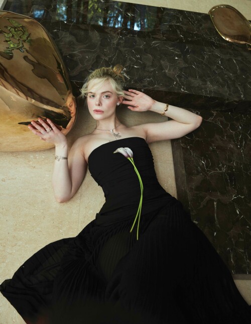 Elle Fanning Photoshoot for Flaunt Magazine 186: The Pomenade Issue, April 2023

Details: GIVENCHY dress and CARTIER earrings, necklace, bracelet, and rings.
VIDERE LICET table.

Elle Fanning Covers The New Issue Of FLAUNT Magazine

Elle Fanning is on the cover of the new issue of FLAUNT magazine. The young actress is on the cover to promote the latest season of her hit comedy series, The Great. Highlights from her interview are below.

On how her and her character, Catherine, have become intertwined: “I have been reflecting a lot on Catherine and myself and how our lives have intertwined. We did the pilot when I was 20 and now, I’m about to turn 25. I’ve been on this show during the most formative years of my life and Catherine has become imprinted on my soul. I wonder if it’s her who’s helped me, or is it me who has just put so much of myself into her? I’m not sure. The lines are starting to blur a lot with the both of us. But it is the most special part I’ve ever had.”

On the production company she started with her sister, Dakota: “I worked with this actor, I won’t say who, but he’s very established. But he said he’d never worked with a female director before,. And I was like ‘What?!’ It was so surprising to me. With our company [Lewellen Pictures] we try to have female writers and directors to tell any story—not just female-driven ones, although of course they’re a focus… but just because you’re a female director doesn’t mean that you have to tell a female-driven story.”

The new season of The Great drops on Hulu on May 12.

#ElleFanning