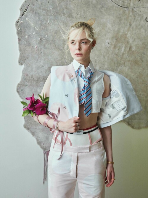 Elle Fanning Photoshoot for Flaunt Magazine 186: The Pomenade Issue, April 2023

Details: THOM BROWNE vest, shirt, pants, tie, and underwear and CARTIER earrings, bracelet, watch, and rings.
HENZEL STUDIO X MARILYN MINTER rug.

ELLE FANNING | LET US COUNT THE WAYS: MISTAKE MAKING, MULTIFACETED, AND MAGNIFICENT

It’s a glorious spring day and one of the first where Los Angeles has seen sunshine in a while, after several unusually bleak winter months. Light beams in through tall, glass windows and onto actor, Elle Fanning, who is now back at home after finishing up a long stint in London filming season three of The Great—Hulu’s hit period drama in which she portrays eighteenth-century Russian empress, Catherine the Great. She’s excited to talk about the show from the get-go. “This season is probably full of the most twists, turns, and surprises yet,” she laughs, as the bright sunshine continues to pour into her home. “A lot of unexpected things are going to happen.”

The Great has proven to be a television phenomenon and a defining role for Fanning, who has been a constant presence in Hollywood since childhood. She’s appeared in films as varied as David Fincher’s The Curious Case of Benjamin Button, Nicolas Winding Refn’s The Neon Demon, J.J. Abrams’s Super 8, Sofia Coppola’s Somewhere and The Beguiled, as well as Disney’s Maleficent. When the script for The Great came her way, penned by The Favourite writer, Tony McNamara, she knew it had the potential to be a game-changing part.

“It was unlike anything I’d ever read before,” Fanning says of the script, as she pushes strands of her blonde hair back from her face, which is fashioned into a neat bun. She says she’s learned more about herself through depicting Catherine than in any of her other roles to date. “I’ve really seen myself in a different light playing this character. Like her, I’ve learned to trust my opinions, inklings, and instincts, and to listen to them as I much as I can, and I’m probably not as afraid to fail now because of what Catherine has taught me. She’s made me a stronger woman... I feel like I’ve grown as a woman getting to play such a powerful figure.”

Fanning is warm and gregarious to speak to: she’s passionate about her character, but also her profession and the rights and opportunities for women in the entertainment industry. Her answers are thoughtful but also funny, too—something that coincides with her character in The Great, flexing more comedic bones in the upcoming season. “I have been reflecting a lot on Catherine and myself and how our lives have intertwined,” she laughs, the sunlight reflecting off a delicate,pastel-lemon knit she is wearing. “We did the pilot when I was 20 and now, I’m about to turn 25. I’ve been on this show during the most formative years of my life and Catherine has become imprinted on my soul. I wonder if it’s her who’s helped me, or is it me who has just put so much of myself into her? I’m not sure,” she muses. “The lines are starting to blur a lot with the both of us. But it is the most special part I’ve ever had.”

Season three sees Catherine come into her own as a leader. Two seasons ago, she was an idealistic young bride whose hopes of a loving marriage were soon dashed when she was wedded to Emperor Peter (played by Nicholas Hoult), a wild, cheating husband, who is violent and misogynistic. The intelligent and well-read Catherine manages to eventually usurp him as leader in a coup, but not without making many mistakes along the way.“She’s a very messy character,” Fanning laughs. “I love that her growth and trajectory are not always on the way up—like she crashes and falls. She experiences that a bit more this coming season. She’s wavering and not getting everything done that she wants to get done as problems arise. The unexpected surprises really [alter] the way Catherine views her personal life. There’s a lot of change ahead for her.”

One of these “unexpected surprises” come with the fact that she is, perhaps for the first time, seemingly in love with her husband. At the end of season two, Catherine tries to kill Peter after he sleeps with, and then accidentally kills, her mother(who is played by the brilliant Gillian Anderson). Like much of the show, it’s a darkly comedic, but deeply seedy moment. Peter survives (Catherine kills his double, not him), and the two awkwardly embrace at the end. Something about seeing him alive stirs a remorseful Catherine, while Peter, watching on, seems to finally take her seriously—both as a leader and a wife. “She thinks she’s in love with Peter now, so she’s really focused on him at the moment,” Fanning reveals, saying she loves how Catherine isn’t afraid to change her mind, nor to explore her manifold complex feelings. Like the real Catherine the Great, her character is also becoming more unafraid to explore her sexual identity too, breaking taboos of the time. In Catherine the Great’s lifetime, rumors about her many sexual encounters were rife. There was even one about sleeping with a horse—something that the show addresses early on.

“My Catherine comes into Russia being a virgin and having this totally idealistic and wrong view of what a wedding night is,” Fanning says. “I think the horse rumor that was spread was like the first kind of slut shaming in a way because as we now know, she very openly had lots of lovers and loved sex. We’ve explored a bit of this in the show, but I think it will build even more. We have to get to that part because it was so much a part of her. We’re definitely on the way with that now.”

Fanning says she’s also enjoyed exploring Catherine’s more sinister side, too—something that’s coincided with women “finally,” she says, being given more realistic roles in Hollywood.“For so long, male characters have been written so that they can be the villain, they can be unredeemable, and that’s seen as both watchable and financeable,” Fanning says astutely. “But women can’t really be put in that box for some reason. For us to be ‘financeable,’ it has to be ‘Oh, create the strong, female character who is brave, who always shows up, and who is perfect.’ That’s the type of woman they want to portray on screen. But I’m not interested in that side, because I don’t relate to that. I’m not that type of woman: I make mistakes, I’m multifaceted, as are many other women.”

Fanning continues: “And even shows like Breaking Bad, which I loved, you have a group of men being nasty to one another, and it’s fun to watch. Those are the characters I want to play...and I’m sure other female [actors] out there do too. There are more female characters that are coming out in this vein,” she says, citing those in recentOscar smashesEverything Everywhere All At OnceandTár. “And I think The Great is one of them too,” she continues. “Catherine now gets to be nasty and outspoken. She doesn’t always have to be strong, or to make the right choice. I feel lucky that I get to play someone like her and not some perfect woman who has all the answers.”

Fanning set up a production company in 2021 with her actor sister Dakota, with the aim of bringing more characters like this to the screen and getting more women behind the camera as directors. “I worked with this actor, I won’t say who, but he’s very established. But he said he’d never worked with a female director before,” Fanning recalls. “And I was like ‘What?!’ It was so surprising to me. With our company [Lewellen Pictures] we try to have female writers and directors to tell any story—not just female-driven ones, although of course they’re a focus... but just because you’re a female director doesn’t mean that you have to tell a female-driven story.” She adds that she feels it’s vital that women are in the writer’s room or behind the camera—just like her mentor, Sofia Coppola.

As mentioned, Fanning appeared as a child in Coppola’s acclaimed Somewhere, and later The Beguiled. Fanning says the director’s work left a lasting mark on her—so much so that she wants to direct her own film, “in the next ten years.” Fanning smiles, “She is still a mentor to me. I feel like I can text her and ask her for advice about anything and she would be there for me. I was very lucky to be on a film set at such a young age [Fanning was 11] that was led by a woman because it kind of broke that barrier for me, where it didn’t seem weird at all to have a woman in charge. It was her vision entirely and she was so respected. Seeing her in charge was inspiring for me. And I thought if I ever wanted to make my own things, I could because Sofia did.”

Fanning says she and her sister were also inspired by a number of female actors-turned-producers in the industry who brought more female-led stories to the screen. “In the last few years, I’ve thought a lot about how I can take power back,” she says, when it comes to seeing more realistic portrayals of women on screen. “I’ve started to do that by acquiring books and articles that I want to make into stories. People like Reese Witherspoon, Nicole Kidman, and Jessica Chastain—they’ve made it happen. Sadly, as a woman, I think in this business you have to kind of make that shift.”

Fanning says another reason for creating the roles comes from a “frustrating” audition process where people can shape your career after only seeing you for “15 or 20 minutes”—by not giving you the part or molding you into a different part based on knee-jerk assumptions about who you are. “I’m trying to be more assertive, to not allow people to put me in a box,” she explains, “but I still feel it can be a bit of a battle to get your voice across because inevitably, and what frustrates me a bit about this business, is that your life in the industry is kind of in someone else’s hands. I’m trying to take that power back. I feel like you have to create [those parts you want to see] for yourself.”

Fanning credits the females in her family for her strength when it comes to finding her own voice like this: her sister Dakota, her mother (who she still lives with in LA), and her grandmother, who used to accompany her to sets when she was a child. “They’re all just very outspoken, very opinionated, and very feisty women,” Fanning laughs. “I think they’ve helped me to stand my values.”

Fanning also says these women helped her to stay grounded and avoid the pitfalls that’s beset many other child actors. “I think we’re in an industry where it’s really easy for people to be persuaded, or to just not be grounded,” she explains. “If you don’t have that foundation, that’s when it gets hard for people. Because I had that foundation, and because I knew my worth—because they always told me that—I’m also comfortable saying ‘no’ in this business. If it doesn’t feel right, or it’s not like something I would do or think that is okay, I will say no. I’m only comfortable with that because of my family.”

Fanning has turned down plenty of parts, instead choosing her roles carefully to ones that stand apart—like her role in Nicolas Winding Refn’s outlandish The Neon Demon. In this, Fanning plays an aspiring model in a film that holds a mirror up to the fashion industry.“There are like mini-milestones in my career that jumped me to the next chapter, and I think The Neon Demon was one,” Fanning says. She thinks it was the first role that conveyed her in “an older light,” and, like The Great, helped her to transition from child actor to a leading one. “It was a very polarizing film,” she continues, “some people really hate that film and others love it so much.I discovered in myself that I like choosing [such] films.I like challenging myself and surprising people and not being predictable in any way. I kind of like that people love or hate it: that’s a good spot to be in.”

The film chimed with many for its cutting take on the fashion industry, the treatment of women, and the desire for perfection. Her character in the film, Jesse, has a #MeToo moment long before that movement happened in Hollywood, leading many to say the film was ahead of its time. It also highlighted pressures of social media on young people. “I think it was a little before it’s time in a way of having that [#MeToo] conversation,” Fanning says. “It’s also a film about why people are so obsessed with beauty and asks: ‘What does beauty mean?’ I think there’s this unattainable beauty that everyone goes after that honestly just doesn’t exist—like people will do anything to achieve it and then you never achieve it anyway. That’s the sad part.”

Fanning’s production company ventured further into this world in 2021 with a podcast, One Click, that explored the dangers of a diet pill showcased on social media and freely available to buy on the internet. The podcast was an adaptation of journalist Jessica Wapner’s article, “The Deadly Internet Diet Drug That Cooks People Alive” from The Daily Beast. Fanning narrated the podcast. “It was shocking,” Fanning recalls of the initial article. “It just struck me so much when I read it: a diet pill that literally makes people explode. People take it and overheat from the inside; your insides turn canary yellow,” she says, still clearly shocked at what she discovered. “It stems from the worst sides of social media, in that we’re just constantly comparing ourselves to others. It inevitably happens to all of us. But it’s so much easier to do when you have access to so many images, constantly. With this diet pill, there were a lot of bodybuilders who took it, but also young girls because of wanting to have skinnier thighs.”

Fanning continues: “Everyone falls victim to that. I’m like, ‘Oh god, is my body like this or that, it’s not perfect, it doesn’t look like that person.’”Fanning says growing up, she wasn’t allowed a Facebook account, with her parents trying to protect her from social media. As someone in the spotlight from a young age, however, her image was scattered all over the internet, so much so that she would see pictures of herself growing up in realtime—something she says was a “strange experience—you’re seeing yourself literally change before your very eyes and being confronted with that daily was [odd]. I don’t pay it as much mind anymore, but I think when I was younger, I really obsessed over that a bit,” she explains, saying she can see how social media creates a tough environment for young people across the globe.

While Fanning has an Instagram now, she spends most of her time away from social media, splitting her time between London where she films The Great, and LA with her family (she’s currently deciding where she wants to settle eventually, having fallen in love with London, but also not wanting to be apart from her family). She spends as much time with her sister as possible, too. A previously shelved project that would have seen the pair on screen together for the first time looks set to be revived, something Fanning is thrilled about. It’s calledThe Nightingale, and is a film about two sisters living in France whose lives are torn apart during World War Two.“It’s come back around,” Fanning says enthusiastically of the project. “We’re in talks, and it’s something we’re figuring out because it’s an amazing book and story, and to finally get to play together in a movie—something we’ve never done—as sisters, it will be very special when it happens,” she beams, the excitement of the project palpable. “The pan-demic really affected it, which was so sad. We were about to get on the plane [to start filming] and then the next day, boom, the world shut down.”

Fanning says she is very close to her sister; she circles back to The Neon Demon and shares an anecdote about the first time Dakota saw the film on screen. “I die quite a horrible death in that film,” she laughs. “My sister had to leave the theatre: it really disturbed her. [The scene] with me in the swimming pool, all broken—she was like: ‘I couldn’t watch that, it was making me sick!’ I suppose watching that and then the added layer of it being your sister was hard. I’ve experienced it, too, like in some sad, dark films, and it’s like, ‘Yeah, I’m watching my sister here!’ It’s hard to watch!’”

For now, Fanning is focusing on the next stage of The Great but says that the show does now have an end in sight. “I mean, Tony[McNamara, creator] and all of us [cast and crew], we definitely see an end and we want to wrap it up in a nice ceremonious way and when that’s it, it will be very sad. But I know it has given me so much to move onto in the next stage of my life.”

Fanning says she's not sure the show would have been as successful without the close connection of the cast and crew—something she will miss when the show ends. “I don’t think the show would honestly be as good if we weren’t as comfortable and as close with each other... We get really vulnerable with one another and just share ourselves. That elevates it for sure.” She singles out praise for her co-star (and also former child actor), Nicholas Hoult. “Nick and I are definitely working together again—I just love him so much,” she laughs.“We push each other so much. We work in a very similar way, which might be because we were child actors. And just being onset from a young age, we have the same kind of mentality about how we view our work.”

Fanning is currently planning another podcast as part of the One Click series, and at the back of the chair she occupies is a pile of what looks to be half-opened scripts. Whatever project comes up next, Fanning says she’s not scared to take a risk. “Playing Catherine has taught me to not be afraid to use my voice and stand in my truth. And sometimes, you know, if you fail at that, that’s okay,” she beams, before heading out into the warm LA sunshine, “but at least you stay true to yourself.” The future indeed feels bright for Elle Fanning.

Photographed by Greg Swales
Styled by Mui-Hai Chu
Written by Elizabeth Aubrey
Photographer’s Producer: Alexey Galetskiy
Makeup: Erin Ayanian Monroe
Hair: Jenda Alcorn
Manicurist: Yoko Sakakura
Flaunt Film: Mynxii White
Photo Team: Amanda Yanez, Yolanda Leaney, Maya Sacks
Styling Assistants: David Gomez, Jadalyn Borla
Production Assistants: McKenna Matus, Serafim Mgeladze
Location: Twentieth Gallery

#ElleFanning