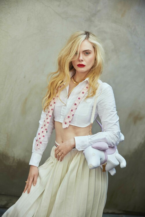 Elle Fanning Photoshoot for Flaunt Magazine 186: The Pomenade Issue, April 2023

Details: THOM BROWNE shirt, skirt, tie, tights, socks, and bag, and CARTIER necklace, watch, and ring.

ELLE FANNING | LET US COUNT THE WAYS: MISTAKE MAKING, MULTIFACETED, AND MAGNIFICENT

It’s a glorious spring day and one of the first where Los Angeles has seen sunshine in a while, after several unusually bleak winter months. Light beams in through tall, glass windows and onto actor, Elle Fanning, who is now back at home after finishing up a long stint in London filming season three of The Great—Hulu’s hit period drama in which she portrays eighteenth-century Russian empress, Catherine the Great. She’s excited to talk about the show from the get-go. “This season is probably full of the most twists, turns, and surprises yet,” she laughs, as the bright sunshine continues to pour into her home. “A lot of unexpected things are going to happen.”

The Great has proven to be a television phenomenon and a defining role for Fanning, who has been a constant presence in Hollywood since childhood. She’s appeared in films as varied as David Fincher’s The Curious Case of Benjamin Button, Nicolas Winding Refn’s The Neon Demon, J.J. Abrams’s Super 8, Sofia Coppola’s Somewhere and The Beguiled, as well as Disney’s Maleficent. When the script for The Great came her way, penned by The Favourite writer, Tony McNamara, she knew it had the potential to be a game-changing part.

“It was unlike anything I’d ever read before,” Fanning says of the script, as she pushes strands of her blonde hair back from her face, which is fashioned into a neat bun. She says she’s learned more about herself through depicting Catherine than in any of her other roles to date. “I’ve really seen myself in a different light playing this character. Like her, I’ve learned to trust my opinions, inklings, and instincts, and to listen to them as I much as I can, and I’m probably not as afraid to fail now because of what Catherine has taught me. She’s made me a stronger woman... I feel like I’ve grown as a woman getting to play such a powerful figure.”

Fanning is warm and gregarious to speak to: she’s passionate about her character, but also her profession and the rights and opportunities for women in the entertainment industry. Her answers are thoughtful but also funny, too—something that coincides with her character in The Great, flexing more comedic bones in the upcoming season. “I have been reflecting a lot on Catherine and myself and how our lives have intertwined,” she laughs, the sunlight reflecting off a delicate,pastel-lemon knit she is wearing. “We did the pilot when I was 20 and now, I’m about to turn 25. I’ve been on this show during the most formative years of my life and Catherine has become imprinted on my soul. I wonder if it’s her who’s helped me, or is it me who has just put so much of myself into her? I’m not sure,” she muses. “The lines are starting to blur a lot with the both of us. But it is the most special part I’ve ever had.”

Season three sees Catherine come into her own as a leader. Two seasons ago, she was an idealistic young bride whose hopes of a loving marriage were soon dashed when she was wedded to Emperor Peter (played by Nicholas Hoult), a wild, cheating husband, who is violent and misogynistic. The intelligent and well-read Catherine manages to eventually usurp him as leader in a coup, but not without making many mistakes along the way.“She’s a very messy character,” Fanning laughs. “I love that her growth and trajectory are not always on the way up—like she crashes and falls. She experiences that a bit more this coming season. She’s wavering and not getting everything done that she wants to get done as problems arise. The unexpected surprises really [alter] the way Catherine views her personal life. There’s a lot of change ahead for her.”

One of these “unexpected surprises” come with the fact that she is, perhaps for the first time, seemingly in love with her husband. At the end of season two, Catherine tries to kill Peter after he sleeps with, and then accidentally kills, her mother(who is played by the brilliant Gillian Anderson). Like much of the show, it’s a darkly comedic, but deeply seedy moment. Peter survives (Catherine kills his double, not him), and the two awkwardly embrace at the end. Something about seeing him alive stirs a remorseful Catherine, while Peter, watching on, seems to finally take her seriously—both as a leader and a wife. “She thinks she’s in love with Peter now, so she’s really focused on him at the moment,” Fanning reveals, saying she loves how Catherine isn’t afraid to change her mind, nor to explore her manifold complex feelings. Like the real Catherine the Great, her character is also becoming more unafraid to explore her sexual identity too, breaking taboos of the time. In Catherine the Great’s lifetime, rumors about her many sexual encounters were rife. There was even one about sleeping with a horse—something that the show addresses early on.

“My Catherine comes into Russia being a virgin and having this totally idealistic and wrong view of what a wedding night is,” Fanning says. “I think the horse rumor that was spread was like the first kind of slut shaming in a way because as we now know, she very openly had lots of lovers and loved sex. We’ve explored a bit of this in the show, but I think it will build even more. We have to get to that part because it was so much a part of her. We’re definitely on the way with that now.”

Fanning says she’s also enjoyed exploring Catherine’s more sinister side, too—something that’s coincided with women “finally,” she says, being given more realistic roles in Hollywood.“For so long, male characters have been written so that they can be the villain, they can be unredeemable, and that’s seen as both watchable and financeable,” Fanning says astutely. “But women can’t really be put in that box for some reason. For us to be ‘financeable,’ it has to be ‘Oh, create the strong, female character who is brave, who always shows up, and who is perfect.’ That’s the type of woman they want to portray on screen. But I’m not interested in that side, because I don’t relate to that. I’m not that type of woman: I make mistakes, I’m multifaceted, as are many other women.”

Fanning continues: “And even shows like Breaking Bad, which I loved, you have a group of men being nasty to one another, and it’s fun to watch. Those are the characters I want to play...and I’m sure other female [actors] out there do too. There are more female characters that are coming out in this vein,” she says, citing those in recentOscar smashesEverything Everywhere All At OnceandTár. “And I think The Great is one of them too,” she continues. “Catherine now gets to be nasty and outspoken. She doesn’t always have to be strong, or to make the right choice. I feel lucky that I get to play someone like her and not some perfect woman who has all the answers.”

Fanning set up a production company in 2021 with her actor sister Dakota, with the aim of bringing more characters like this to the screen and getting more women behind the camera as directors. “I worked with this actor, I won’t say who, but he’s very established. But he said he’d never worked with a female director before,” Fanning recalls. “And I was like ‘What?!’ It was so surprising to me. With our company [Lewellen Pictures] we try to have female writers and directors to tell any story—not just female-driven ones, although of course they’re a focus... but just because you’re a female director doesn’t mean that you have to tell a female-driven story.” She adds that she feels it’s vital that women are in the writer’s room or behind the camera—just like her mentor, Sofia Coppola.

As mentioned, Fanning appeared as a child in Coppola’s acclaimed Somewhere, and later The Beguiled. Fanning says the director’s work left a lasting mark on her—so much so that she wants to direct her own film, “in the next ten years.” Fanning smiles, “She is still a mentor to me. I feel like I can text her and ask her for advice about anything and she would be there for me. I was very lucky to be on a film set at such a young age [Fanning was 11] that was led by a woman because it kind of broke that barrier for me, where it didn’t seem weird at all to have a woman in charge. It was her vision entirely and she was so respected. Seeing her in charge was inspiring for me. And I thought if I ever wanted to make my own things, I could because Sofia did.”

Fanning says she and her sister were also inspired by a number of female actors-turned-producers in the industry who brought more female-led stories to the screen. “In the last few years, I’ve thought a lot about how I can take power back,” she says, when it comes to seeing more realistic portrayals of women on screen. “I’ve started to do that by acquiring books and articles that I want to make into stories. People like Reese Witherspoon, Nicole Kidman, and Jessica Chastain—they’ve made it happen. Sadly, as a woman, I think in this business you have to kind of make that shift.”

Fanning says another reason for creating the roles comes from a “frustrating” audition process where people can shape your career after only seeing you for “15 or 20 minutes”—by not giving you the part or molding you into a different part based on knee-jerk assumptions about who you are. “I’m trying to be more assertive, to not allow people to put me in a box,” she explains, “but I still feel it can be a bit of a battle to get your voice across because inevitably, and what frustrates me a bit about this business, is that your life in the industry is kind of in someone else’s hands. I’m trying to take that power back. I feel like you have to create [those parts you want to see] for yourself.”

Fanning credits the females in her family for her strength when it comes to finding her own voice like this: her sister Dakota, her mother (who she still lives with in LA), and her grandmother, who used to accompany her to sets when she was a child. “They’re all just very outspoken, very opinionated, and very feisty women,” Fanning laughs. “I think they’ve helped me to stand my values.”

Fanning also says these women helped her to stay grounded and avoid the pitfalls that’s beset many other child actors. “I think we’re in an industry where it’s really easy for people to be persuaded, or to just not be grounded,” she explains. “If you don’t have that foundation, that’s when it gets hard for people. Because I had that foundation, and because I knew my worth—because they always told me that—I’m also comfortable saying ‘no’ in this business. If it doesn’t feel right, or it’s not like something I would do or think that is okay, I will say no. I’m only comfortable with that because of my family.”

Fanning has turned down plenty of parts, instead choosing her roles carefully to ones that stand apart—like her role in Nicolas Winding Refn’s outlandish The Neon Demon. In this, Fanning plays an aspiring model in a film that holds a mirror up to the fashion industry.“There are like mini-milestones in my career that jumped me to the next chapter, and I think The Neon Demon was one,” Fanning says. She thinks it was the first role that conveyed her in “an older light,” and, like The Great, helped her to transition from child actor to a leading one. “It was a very polarizing film,” she continues, “some people really hate that film and others love it so much.I discovered in myself that I like choosing [such] films.I like challenging myself and surprising people and not being predictable in any way. I kind of like that people love or hate it: that’s a good spot to be in.”

The film chimed with many for its cutting take on the fashion industry, the treatment of women, and the desire for perfection. Her character in the film, Jesse, has a #MeToo moment long before that movement happened in Hollywood, leading many to say the film was ahead of its time. It also highlighted pressures of social media on young people. “I think it was a little before it’s time in a way of having that [#MeToo] conversation,” Fanning says. “It’s also a film about why people are so obsessed with beauty and asks: ‘What does beauty mean?’ I think there’s this unattainable beauty that everyone goes after that honestly just doesn’t exist—like people will do anything to achieve it and then you never achieve it anyway. That’s the sad part.”

Fanning’s production company ventured further into this world in 2021 with a podcast, One Click, that explored the dangers of a diet pill showcased on social media and freely available to buy on the internet. The podcast was an adaptation of journalist Jessica Wapner’s article, “The Deadly Internet Diet Drug That Cooks People Alive” from The Daily Beast. Fanning narrated the podcast. “It was shocking,” Fanning recalls of the initial article. “It just struck me so much when I read it: a diet pill that literally makes people explode. People take it and overheat from the inside; your insides turn canary yellow,” she says, still clearly shocked at what she discovered. “It stems from the worst sides of social media, in that we’re just constantly comparing ourselves to others. It inevitably happens to all of us. But it’s so much easier to do when you have access to so many images, constantly. With this diet pill, there were a lot of bodybuilders who took it, but also young girls because of wanting to have skinnier thighs.”

Fanning continues: “Everyone falls victim to that. I’m like, ‘Oh god, is my body like this or that, it’s not perfect, it doesn’t look like that person.’”Fanning says growing up, she wasn’t allowed a Facebook account, with her parents trying to protect her from social media. As someone in the spotlight from a young age, however, her image was scattered all over the internet, so much so that she would see pictures of herself growing up in realtime—something she says was a “strange experience—you’re seeing yourself literally change before your very eyes and being confronted with that daily was [odd]. I don’t pay it as much mind anymore, but I think when I was younger, I really obsessed over that a bit,” she explains, saying she can see how social media creates a tough environment for young people across the globe.

While Fanning has an Instagram now, she spends most of her time away from social media, splitting her time between London where she films The Great, and LA with her family (she’s currently deciding where she wants to settle eventually, having fallen in love with London, but also not wanting to be apart from her family). She spends as much time with her sister as possible, too. A previously shelved project that would have seen the pair on screen together for the first time looks set to be revived, something Fanning is thrilled about. It’s calledThe Nightingale, and is a film about two sisters living in France whose lives are torn apart during World War Two.“It’s come back around,” Fanning says enthusiastically of the project. “We’re in talks, and it’s something we’re figuring out because it’s an amazing book and story, and to finally get to play together in a movie—something we’ve never done—as sisters, it will be very special when it happens,” she beams, the excitement of the project palpable. “The pan-demic really affected it, which was so sad. We were about to get on the plane [to start filming] and then the next day, boom, the world shut down.”

Fanning says she is very close to her sister; she circles back to The Neon Demon and shares an anecdote about the first time Dakota saw the film on screen. “I die quite a horrible death in that film,” she laughs. “My sister had to leave the theatre: it really disturbed her. [The scene] with me in the swimming pool, all broken—she was like: ‘I couldn’t watch that, it was making me sick!’ I suppose watching that and then the added layer of it being your sister was hard. I’ve experienced it, too, like in some sad, dark films, and it’s like, ‘Yeah, I’m watching my sister here!’ It’s hard to watch!’”

For now, Fanning is focusing on the next stage of The Great but says that the show does now have an end in sight. “I mean, Tony[McNamara, creator] and all of us [cast and crew], we definitely see an end and we want to wrap it up in a nice ceremonious way and when that’s it, it will be very sad. But I know it has given me so much to move onto in the next stage of my life.”

Fanning says she's not sure the show would have been as successful without the close connection of the cast and crew—something she will miss when the show ends. “I don’t think the show would honestly be as good if we weren’t as comfortable and as close with each other... We get really vulnerable with one another and just share ourselves. That elevates it for sure.” She singles out praise for her co-star (and also former child actor), Nicholas Hoult. “Nick and I are definitely working together again—I just love him so much,” she laughs.“We push each other so much. We work in a very similar way, which might be because we were child actors. And just being onset from a young age, we have the same kind of mentality about how we view our work.”

Fanning is currently planning another podcast as part of the One Click series, and at the back of the chair she occupies is a pile of what looks to be half-opened scripts. Whatever project comes up next, Fanning says she’s not scared to take a risk. “Playing Catherine has taught me to not be afraid to use my voice and stand in my truth. And sometimes, you know, if you fail at that, that’s okay,” she beams, before heading out into the warm LA sunshine, “but at least you stay true to yourself.” The future indeed feels bright for Elle Fanning.

Photographed by Greg Swales
Styled by Mui-Hai Chu
Written by Elizabeth Aubrey
Photographer’s Producer: Alexey Galetskiy
Makeup: Erin Ayanian Monroe
Hair: Jenda Alcorn
Manicurist: Yoko Sakakura
Flaunt Film: Mynxii White
Photo Team: Amanda Yanez, Yolanda Leaney, Maya Sacks
Styling Assistants: David Gomez, Jadalyn Borla
Production Assistants: McKenna Matus, Serafim Mgeladze
Location: Twentieth Gallery

#ElleFanning