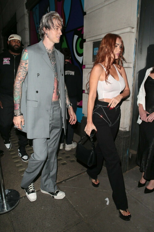 Megan Fox and Machine Gun Kelly Attend an Event in London Together amid Rekindling Their Romance

The couple were spotted together after a source recently told PEOPLE that they are working on "making their relationship better"

Megan Fox and Machine Gun Kelly just touched down in London town.

The couple was spotted attending an event in London together on Tuesday night after a source recently told PEOPLE that they are working on "making their relationship better."

With her new ginger hair on display, the 37-year-old actress sported a white see-through asymmetrical tank and studded black pants with a matching handbag and platform heels.
The 33-year-old musician showed off his tatted arms in a sleeveless oversized gray suit. He completed the look with a long dangling chain necklace and black-and-white sneakers.

Megan Fox and MGK 'Still Not Back to Normal' as They Try for 'Better' Relationship: Source (Exclusive)
Last week, a source told PEOPLE of the couple, "They are back together. They have explored therapy. Things are still not back to normal though."

The couple have been engaged since January 2022.

The source added that Fox and MGK "were wedding planning, but not anymore. They don't have a wedding date. Megan still seems hesitant."

"She has just put so much time into their relationship. It's hard for her to let go," said the source.

Megan Fox, Machine Gun Kelly 'Slowly' Reconciling — But Wedding Planning Is 'Halted': Source (Exclusive)
The Jennifer's Body actress hinted at a possible breakup this past February, removing photos of her musician fiancé from her Instagram account and posting a cryptic caption. A week later, she returned to Instagram to break her silence amid speculation that their relationship might be over.

Fox wrote at the time, "There has been no third party interference in this relationship of any kind. That includes, but is not limited to...actual humans, DMs, AI bots or succubus demons."

In April, the two were photographed holding hands on a trip to Hawaii. And earlier this month, MGK showed up to the Sports Illustrated Swimsuit issue launch to support Fox, who is a cover star this year. However, the pair did not walk the red carpet together.

After that public sighting, a separate insider told PEOPLE their wedding planning "remains halted" even as they gradually repair their relationship.

"He's doing whatever he can to get her back, and she's making him work for it. It's still an unhealthy dynamic though, and their friends just don't see this lasting," the insider said. "He has a lot of proving himself to do, and he doesn't want to give her up. He is great with her kids and super hands-on. It's a work in progress."

people.com

#MeganFox