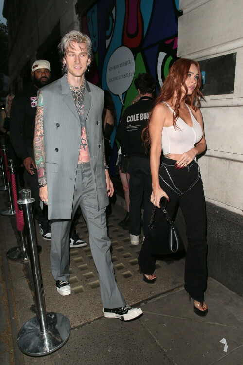 Megan Fox and Machine Gun Kelly Attend an Event in London Together amid Rekindling Their Romance

The couple were spotted together after a source recently told PEOPLE that they are working on "making their relationship better"

Megan Fox and Machine Gun Kelly just touched down in London town.

The couple was spotted attending an event in London together on Tuesday night after a source recently told PEOPLE that they are working on "making their relationship better."

With her new ginger hair on display, the 37-year-old actress sported a white see-through asymmetrical tank and studded black pants with a matching handbag and platform heels.
The 33-year-old musician showed off his tatted arms in a sleeveless oversized gray suit. He completed the look with a long dangling chain necklace and black-and-white sneakers.

Megan Fox and MGK 'Still Not Back to Normal' as They Try for 'Better' Relationship: Source (Exclusive)
Last week, a source told PEOPLE of the couple, "They are back together. They have explored therapy. Things are still not back to normal though."

The couple have been engaged since January 2022.

The source added that Fox and MGK "were wedding planning, but not anymore. They don't have a wedding date. Megan still seems hesitant."

"She has just put so much time into their relationship. It's hard for her to let go," said the source.

Megan Fox, Machine Gun Kelly 'Slowly' Reconciling — But Wedding Planning Is 'Halted': Source (Exclusive)
The Jennifer's Body actress hinted at a possible breakup this past February, removing photos of her musician fiancé from her Instagram account and posting a cryptic caption. A week later, she returned to Instagram to break her silence amid speculation that their relationship might be over.

Fox wrote at the time, "There has been no third party interference in this relationship of any kind. That includes, but is not limited to...actual humans, DMs, AI bots or succubus demons."

In April, the two were photographed holding hands on a trip to Hawaii. And earlier this month, MGK showed up to the Sports Illustrated Swimsuit issue launch to support Fox, who is a cover star this year. However, the pair did not walk the red carpet together.

After that public sighting, a separate insider told PEOPLE their wedding planning "remains halted" even as they gradually repair their relationship.

"He's doing whatever he can to get her back, and she's making him work for it. It's still an unhealthy dynamic though, and their friends just don't see this lasting," the insider said. "He has a lot of proving himself to do, and he doesn't want to give her up. He is great with her kids and super hands-on. It's a work in progress."

people.com

#MeganFox