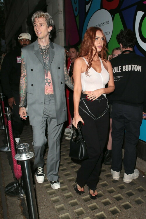 Megan Fox and Machine Gun Kelly Attend an Event in London Together amid Rekindling Their Romance

The couple were spotted together after a source recently told PEOPLE that they are working on "making their relationship better"

Megan Fox and Machine Gun Kelly just touched down in London town.

The couple was spotted attending an event in London together on Tuesday night after a source recently told PEOPLE that they are working on "making their relationship better."

With her new ginger hair on display, the 37-year-old actress sported a white see-through asymmetrical tank and studded black pants with a matching handbag and platform heels.
The 33-year-old musician showed off his tatted arms in a sleeveless oversized gray suit. He completed the look with a long dangling chain necklace and black-and-white sneakers.

Megan Fox and MGK 'Still Not Back to Normal' as They Try for 'Better' Relationship: Source (Exclusive)
Last week, a source told PEOPLE of the couple, "They are back together. They have explored therapy. Things are still not back to normal though."

The couple have been engaged since January 2022.

The source added that Fox and MGK "were wedding planning, but not anymore. They don't have a wedding date. Megan still seems hesitant."

"She has just put so much time into their relationship. It's hard for her to let go," said the source.

Megan Fox, Machine Gun Kelly 'Slowly' Reconciling — But Wedding Planning Is 'Halted': Source (Exclusive)
The Jennifer's Body actress hinted at a possible breakup this past February, removing photos of her musician fiancé from her Instagram account and posting a cryptic caption. A week later, she returned to Instagram to break her silence amid speculation that their relationship might be over.

Fox wrote at the time, "There has been no third party interference in this relationship of any kind. That includes, but is not limited to...actual humans, DMs, AI bots or succubus demons."

In April, the two were photographed holding hands on a trip to Hawaii. And earlier this month, MGK showed up to the Sports Illustrated Swimsuit issue launch to support Fox, who is a cover star this year. However, the pair did not walk the red carpet together.

After that public sighting, a separate insider told PEOPLE their wedding planning "remains halted" even as they gradually repair their relationship.

"He's doing whatever he can to get her back, and she's making him work for it. It's still an unhealthy dynamic though, and their friends just don't see this lasting," the insider said. "He has a lot of proving himself to do, and he doesn't want to give her up. He is great with her kids and super hands-on. It's a work in progress."

people.com

#MeganFox