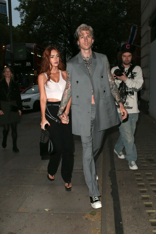 Megan Fox and Machine Gun Kelly Attend an Event in London Together amid Rekindling Their Romance

The couple were spotted together after a source recently told PEOPLE that they are working on "making their relationship better"

Megan Fox and Machine Gun Kelly just touched down in London town.

The couple was spotted attending an event in London together on Tuesday night after a source recently told PEOPLE that they are working on "making their relationship better."

With her new ginger hair on display, the 37-year-old actress sported a white see-through asymmetrical tank and studded black pants with a matching handbag and platform heels.
The 33-year-old musician showed off his tatted arms in a sleeveless oversized gray suit. He completed the look with a long dangling chain necklace and black-and-white sneakers.

Megan Fox and MGK 'Still Not Back to Normal' as They Try for 'Better' Relationship: Source (Exclusive)
Last week, a source told PEOPLE of the couple, "They are back together. They have explored therapy. Things are still not back to normal though."

The couple have been engaged since January 2022.

The source added that Fox and MGK "were wedding planning, but not anymore. They don't have a wedding date. Megan still seems hesitant."

"She has just put so much time into their relationship. It's hard for her to let go," said the source.

Megan Fox, Machine Gun Kelly 'Slowly' Reconciling — But Wedding Planning Is 'Halted': Source (Exclusive)
The Jennifer's Body actress hinted at a possible breakup this past February, removing photos of her musician fiancé from her Instagram account and posting a cryptic caption. A week later, she returned to Instagram to break her silence amid speculation that their relationship might be over.

Fox wrote at the time, "There has been no third party interference in this relationship of any kind. That includes, but is not limited to...actual humans, DMs, AI bots or succubus demons."

In April, the two were photographed holding hands on a trip to Hawaii. And earlier this month, MGK showed up to the Sports Illustrated Swimsuit issue launch to support Fox, who is a cover star this year. However, the pair did not walk the red carpet together.

After that public sighting, a separate insider told PEOPLE their wedding planning "remains halted" even as they gradually repair their relationship.

"He's doing whatever he can to get her back, and she's making him work for it. It's still an unhealthy dynamic though, and their friends just don't see this lasting," the insider said. "He has a lot of proving himself to do, and he doesn't want to give her up. He is great with her kids and super hands-on. It's a work in progress."

people.com

#MeganFox