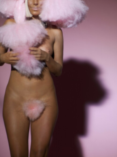 The Lady GaGa shoot appears in the Fall 2009 issue of V Magazine

Lady GaGa strips off (in the name of fashion) for most outrageous shoot yet

Her personal style is famously eccentric - but Lady GaGa's latest photo shoot is probably her most outrageous to date, but this time, because of what she's NOT wearing.

Sporting nothing but a fluffy pink wig and copious amounts of fake tan, the singer flaunted an enviable figure for legendary fashion photographer Mario Testino.

The series of images, which appear in the latest issue of U.S. magazine V, push the boundaries of acceptability, and like many of her ensembles, are unlikely to appeal to everyone's tastes.

Protecting her modesty with a matching pink merkin, the 23-year-old displayed a large tattoo across her back.

She poses in another photograph wearing the same bizarre ensemble, this time holding a cigarette - a risky move, perhaps, for a star with so many impressionable young fans.

In a third image, the Poker Face singer swaps the pink afro for a more familiar blonde, fringed style.

Wearing a sequinned purple and white blouse, she sports towering Seventies-style platforms, rested high above her head against a giant poster of her face.

Today, rumours emerged that Lady GaGa had collaborated with Michael Bolton on his latest album, One World One Love.

The veteran singer claims that when the blonde Let's Dance star approached him, he had no idea who she was.

'I was taking a break from production when my manager and the label tag-teamed me on the phone about writing with a young artist named Lady Gaga who I had never heard of - but they were raving about - they said that she was a huge fan of mine and wanted to write with me,' he said, according to celebrity blogger Perez Hilton.

'She reminded me of a young Madonna - with more exuberance and emphasis on the art rather than the marketing,' he added.

DailyMail

#LadyGaga